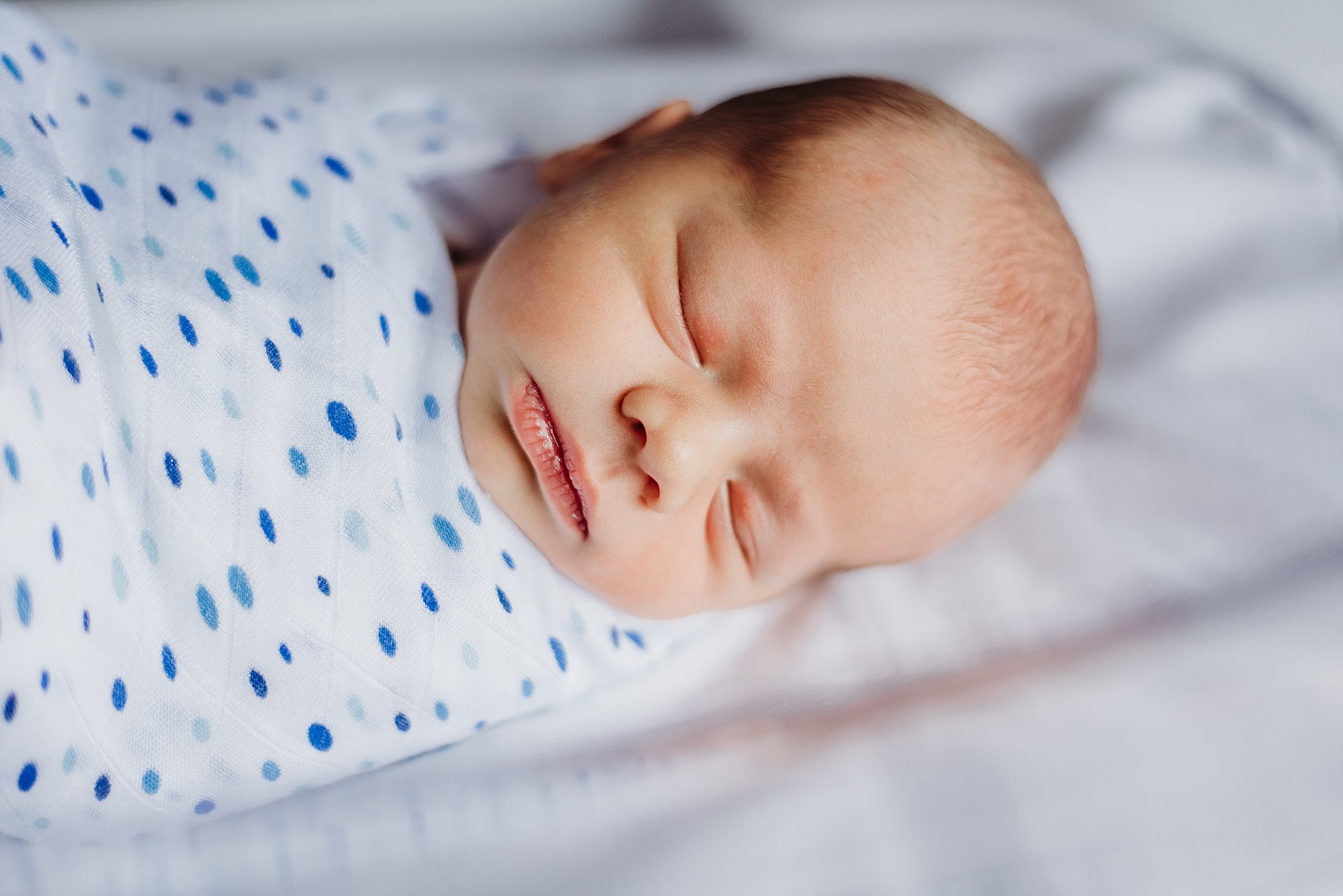 newborn baby boy in hospital bassinet
