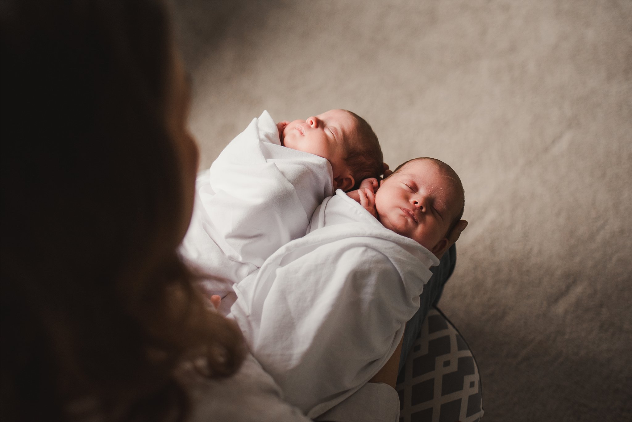 newborn twin girls swaddled and sleeping