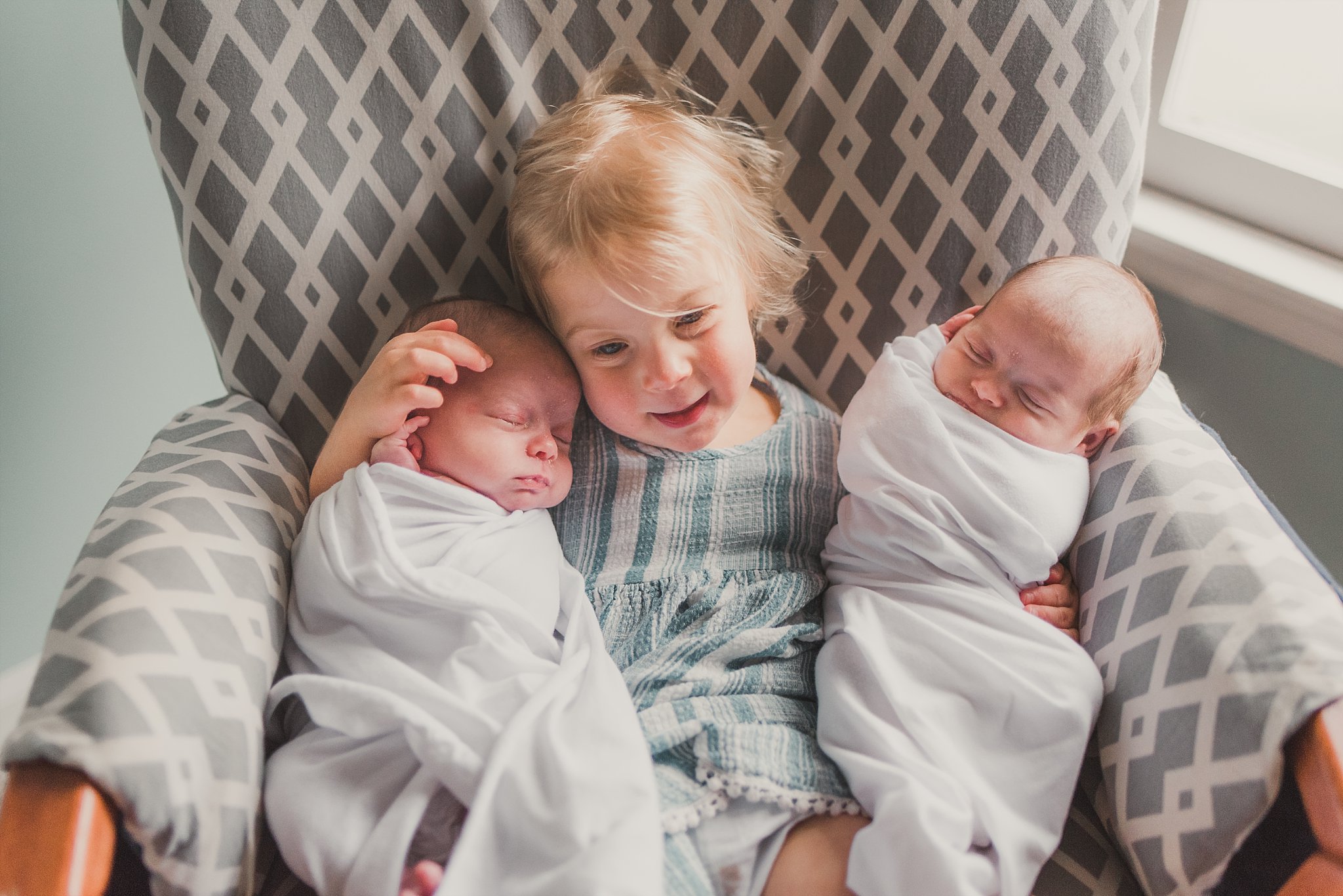 toddler and newborn twins in rocker