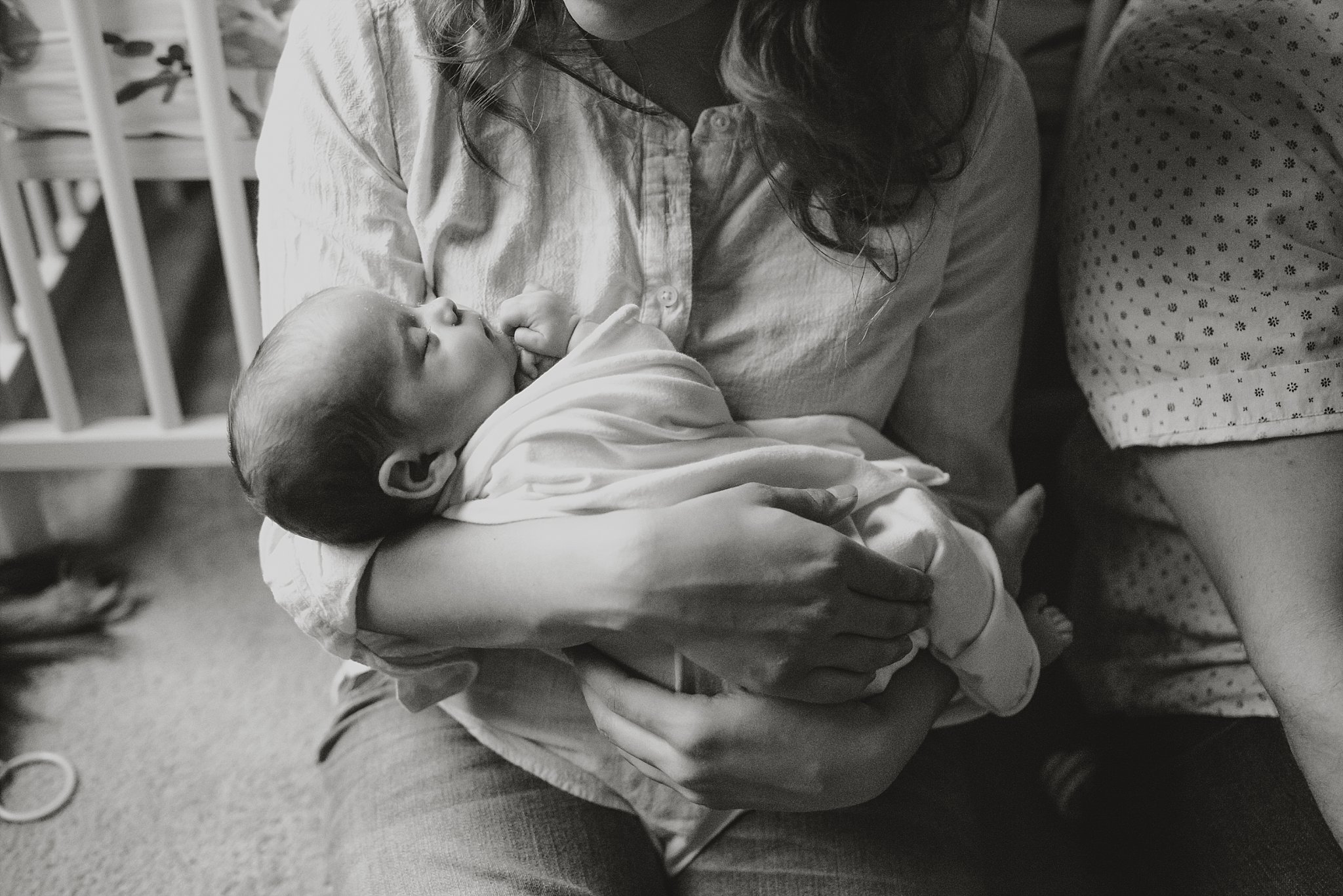 newborn baby in moms arms