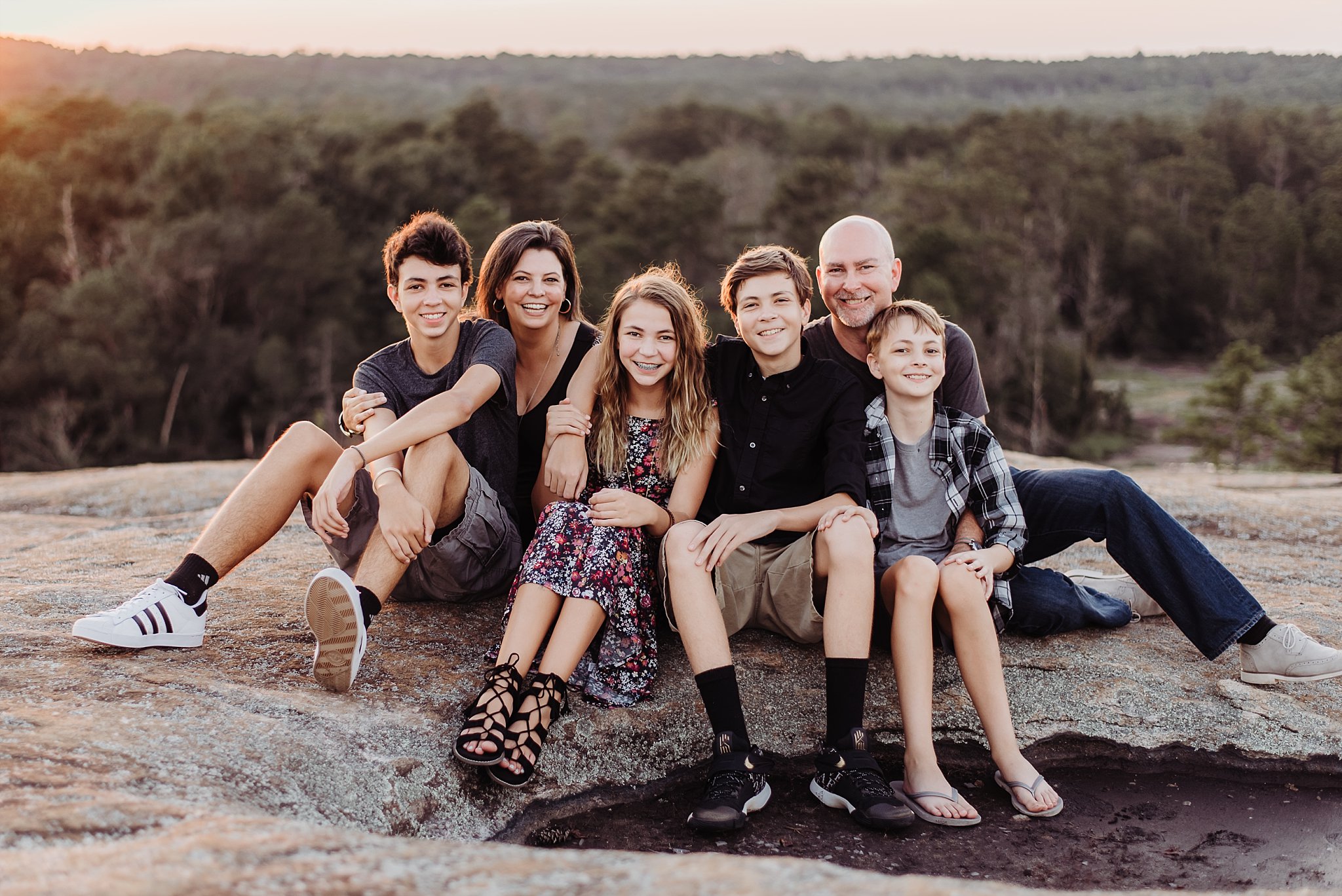 Family sitting at sunset on Arabia Mountain Atlanta