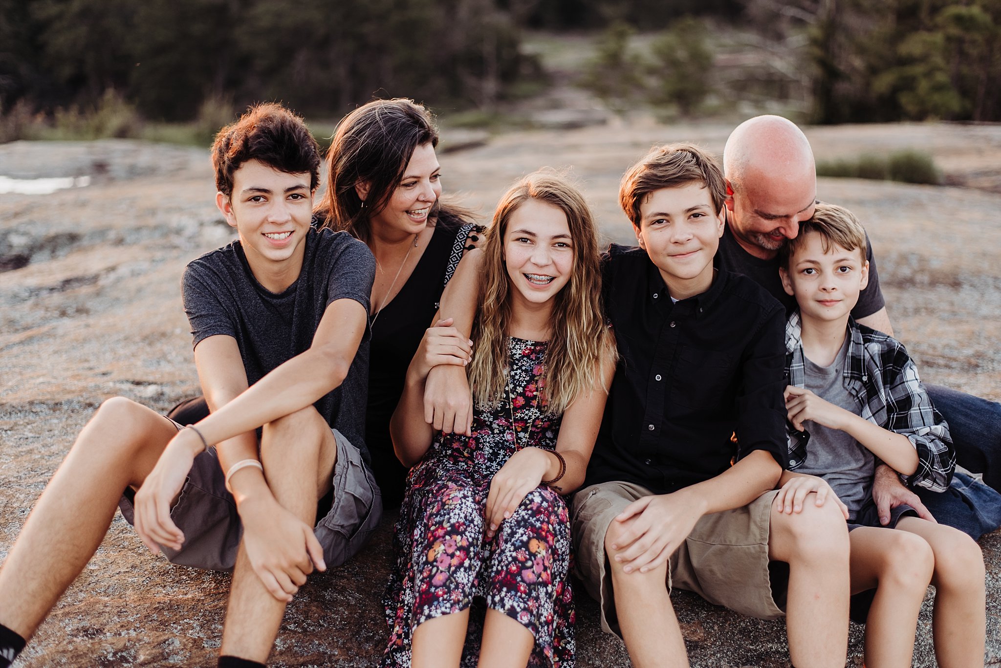 Family laughing sitting at Arabia Mountain Atlanta