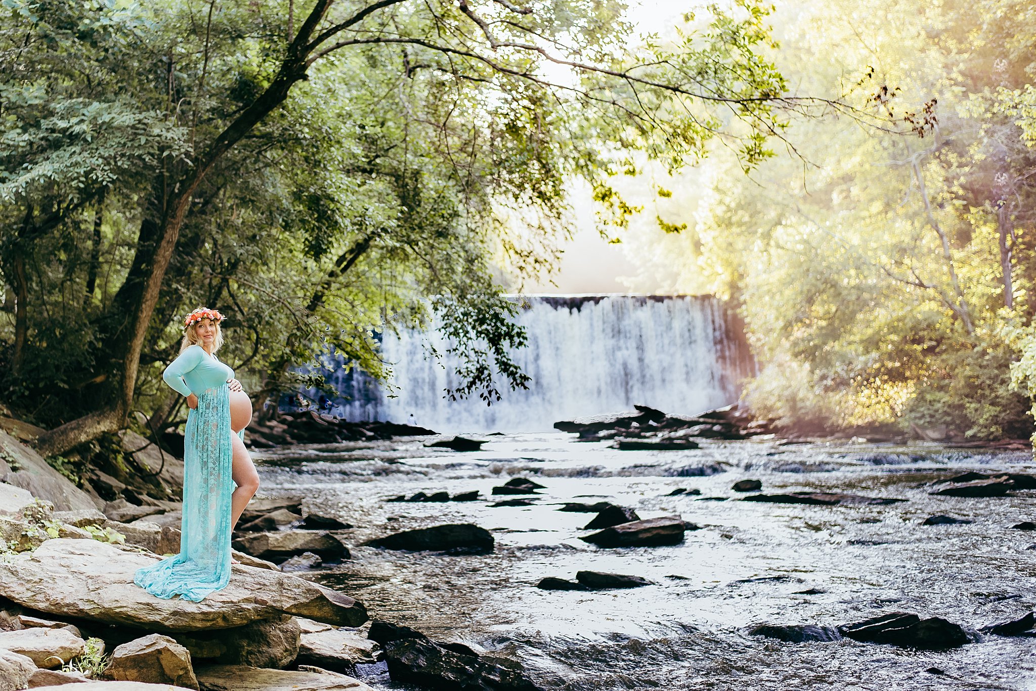 pregnant mom in sheer gown with flower crown at Roswell Mill Waterfall