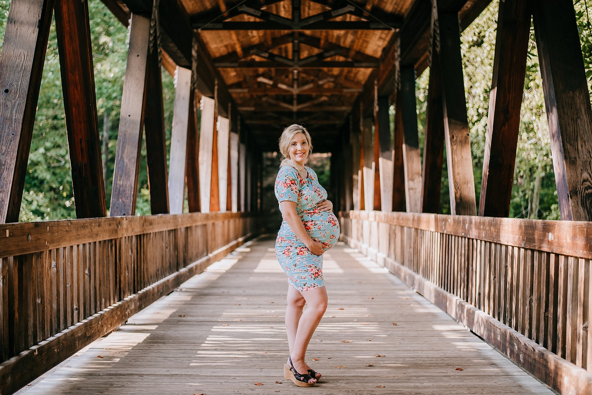 Pregnant mom on covered bridge at Roswell mill