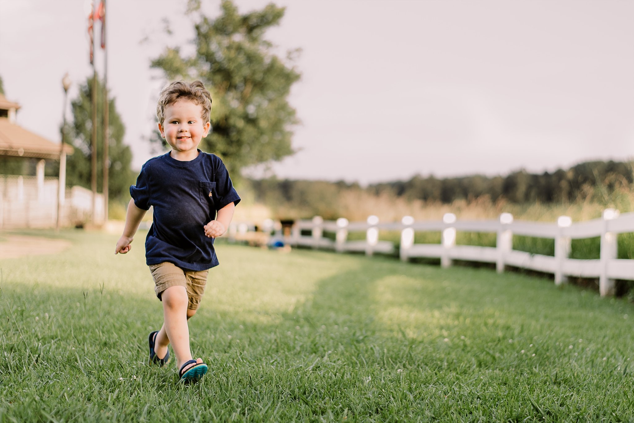 toddler boy running and laughing at Lake Acworth Cauble Park
