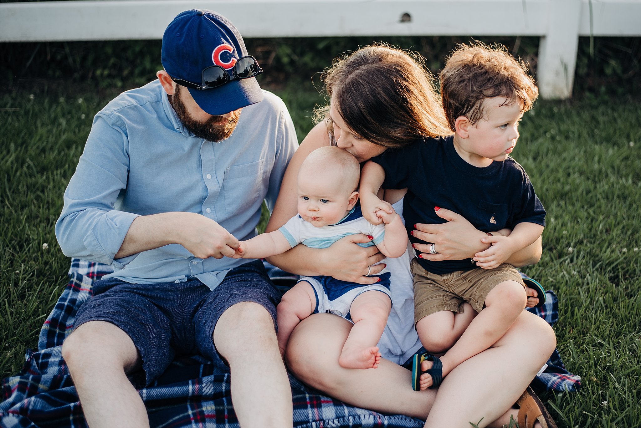 family of 4 on blanket Lake Acworth Cauble Park