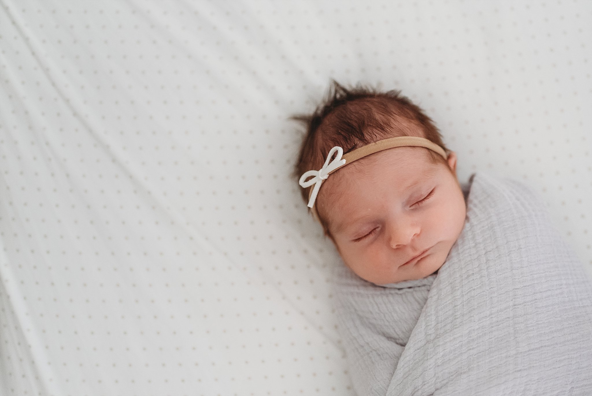 newborn baby girl sleeping in crib