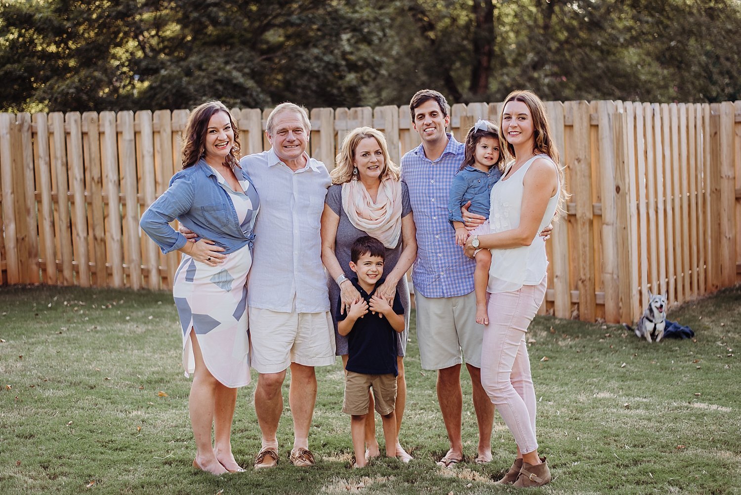 family photo in backyard with fence