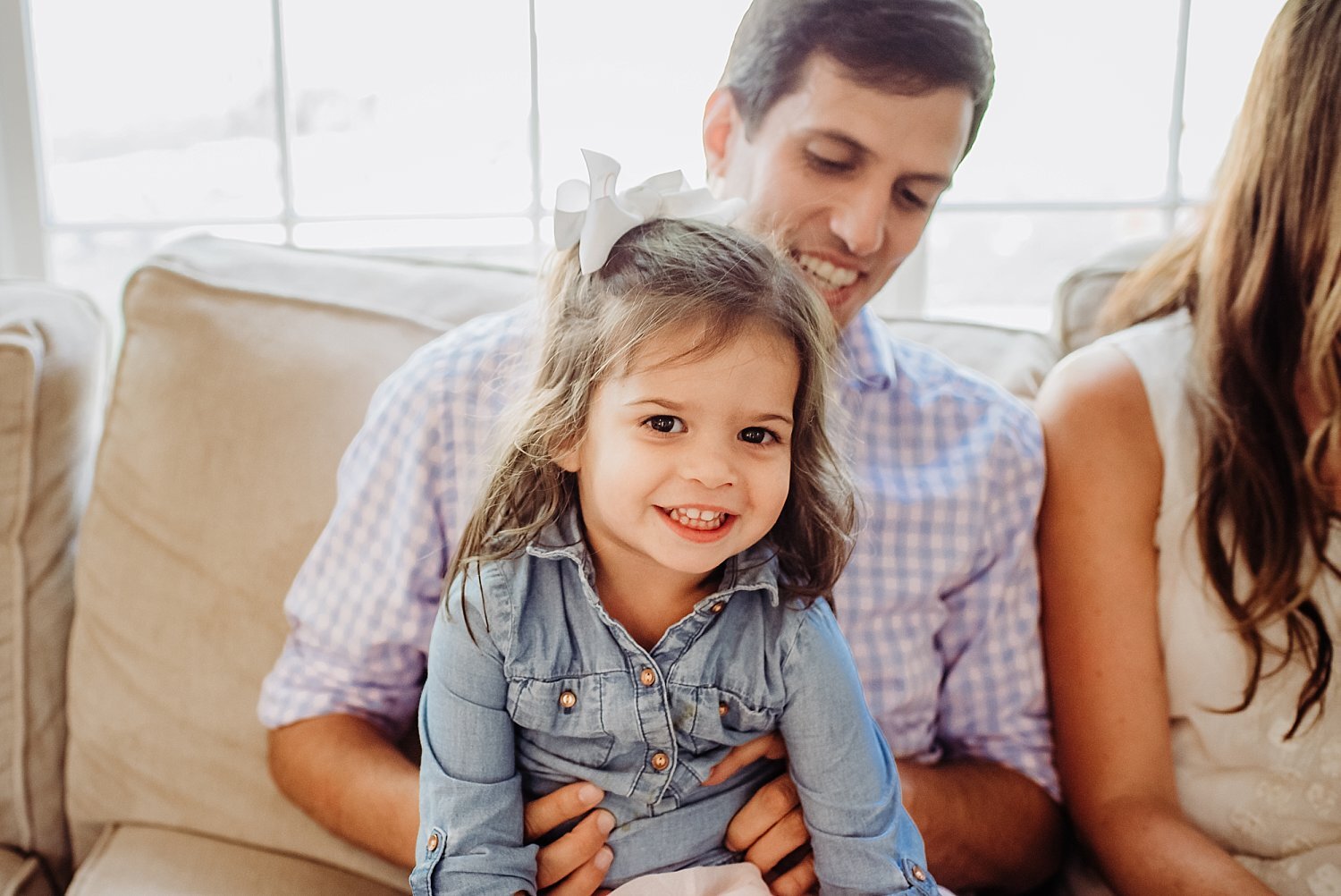 little girl sitting in dad's lap in-home family session Roswell, GA