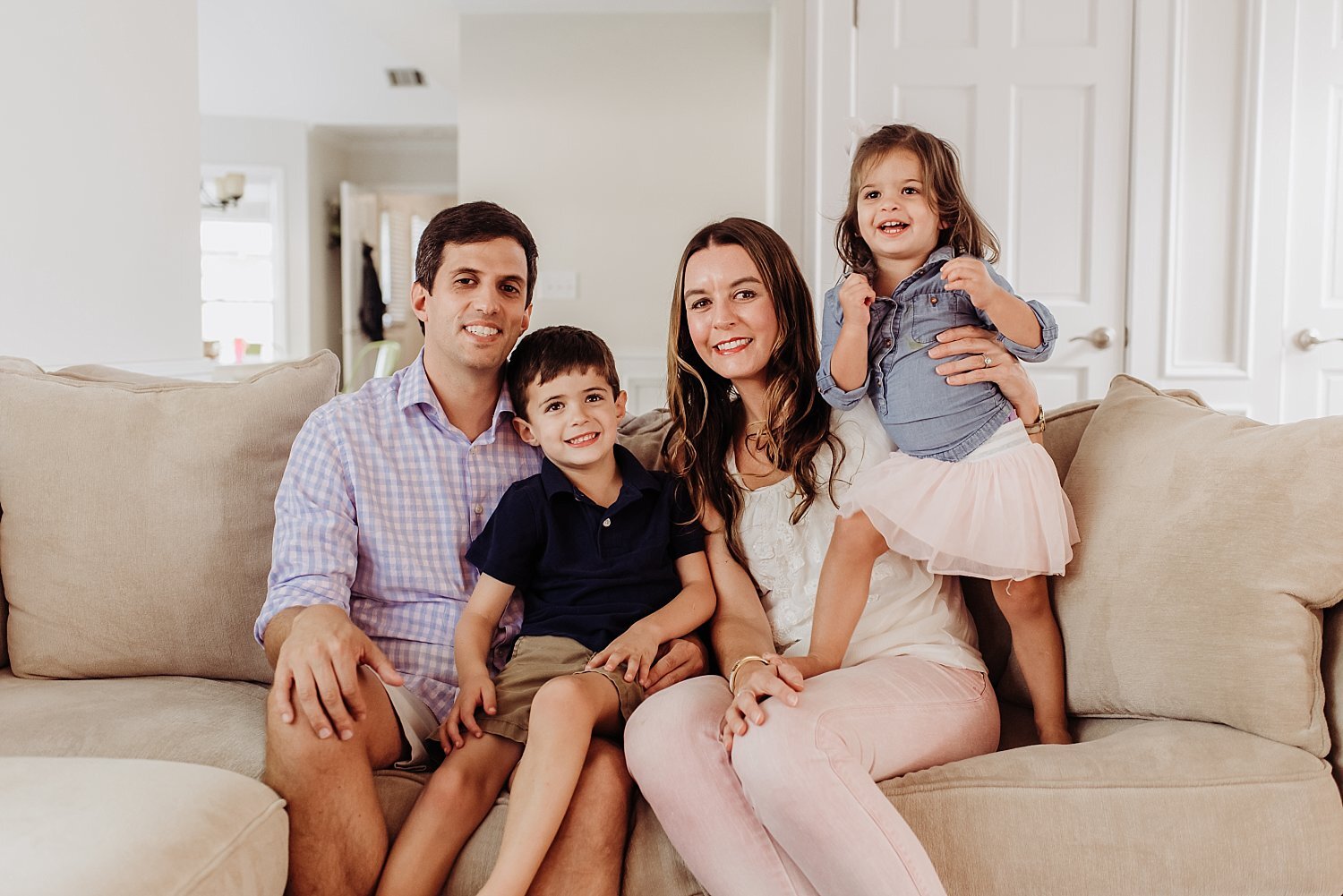 Family of 4 on couch at in-home family session in Roswell, GA