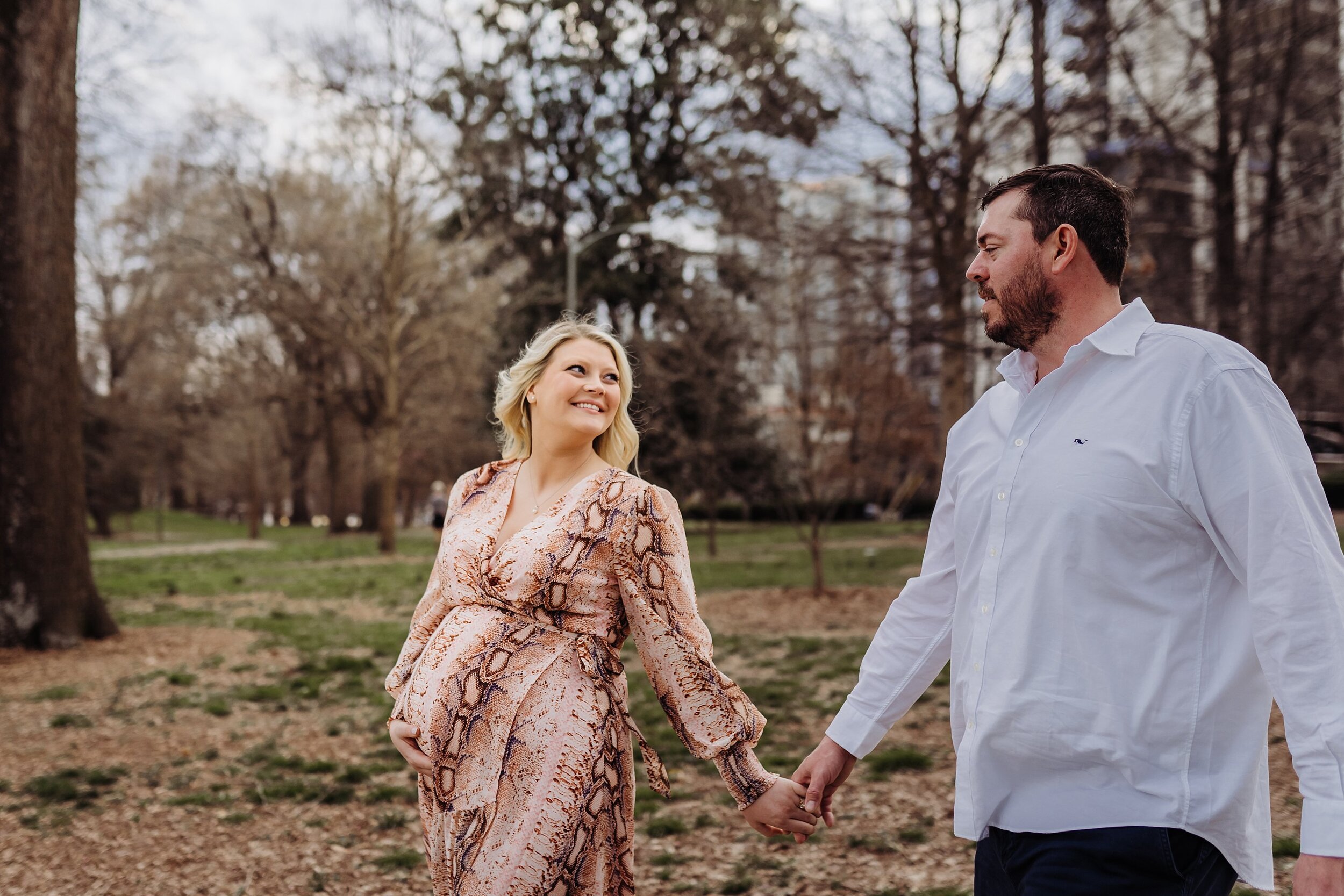 couple holding hands walking in Piedmont Park