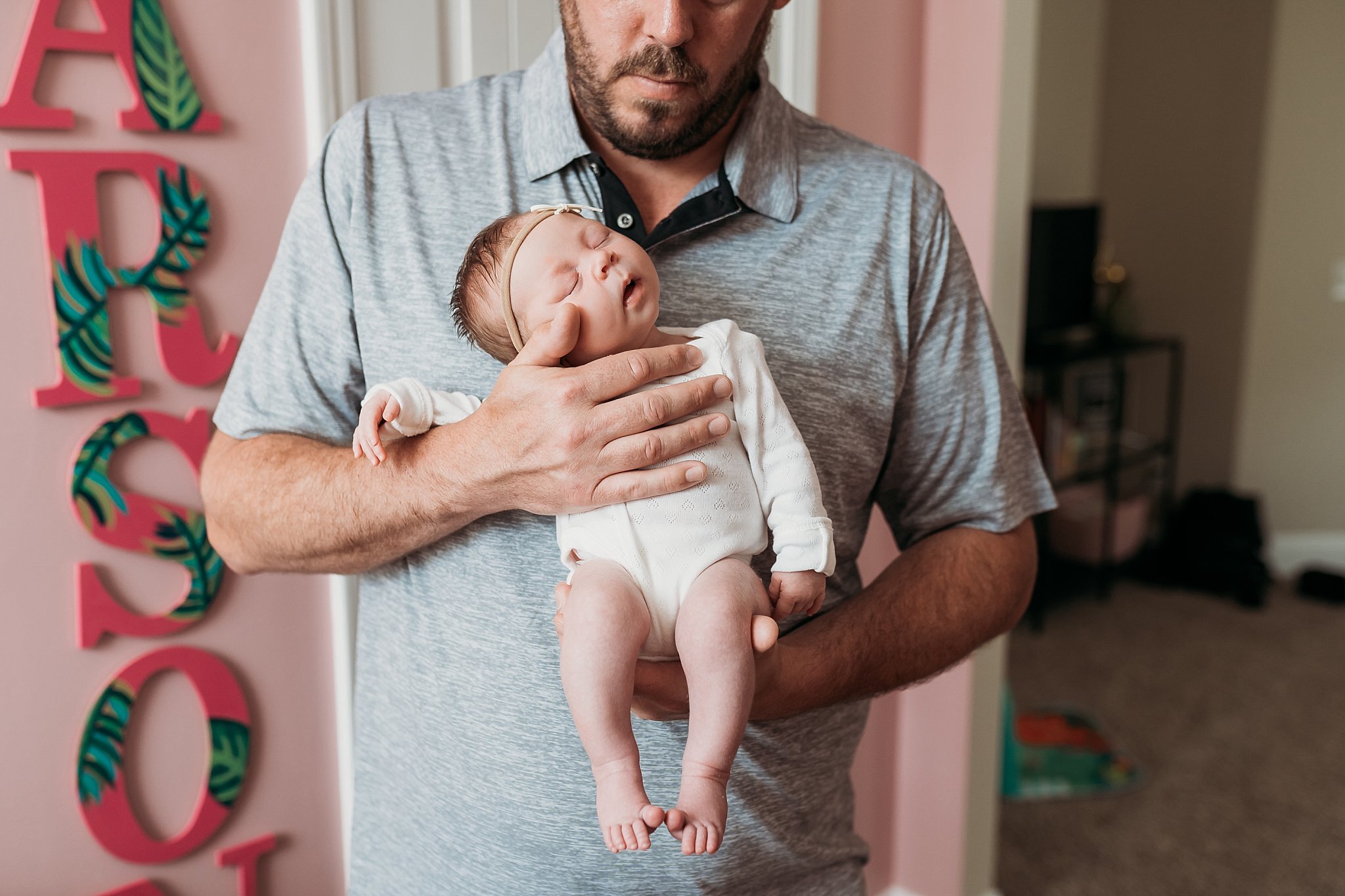 dad holding sleeping newborn baby against chest | Atlanta In Home Newborn Session