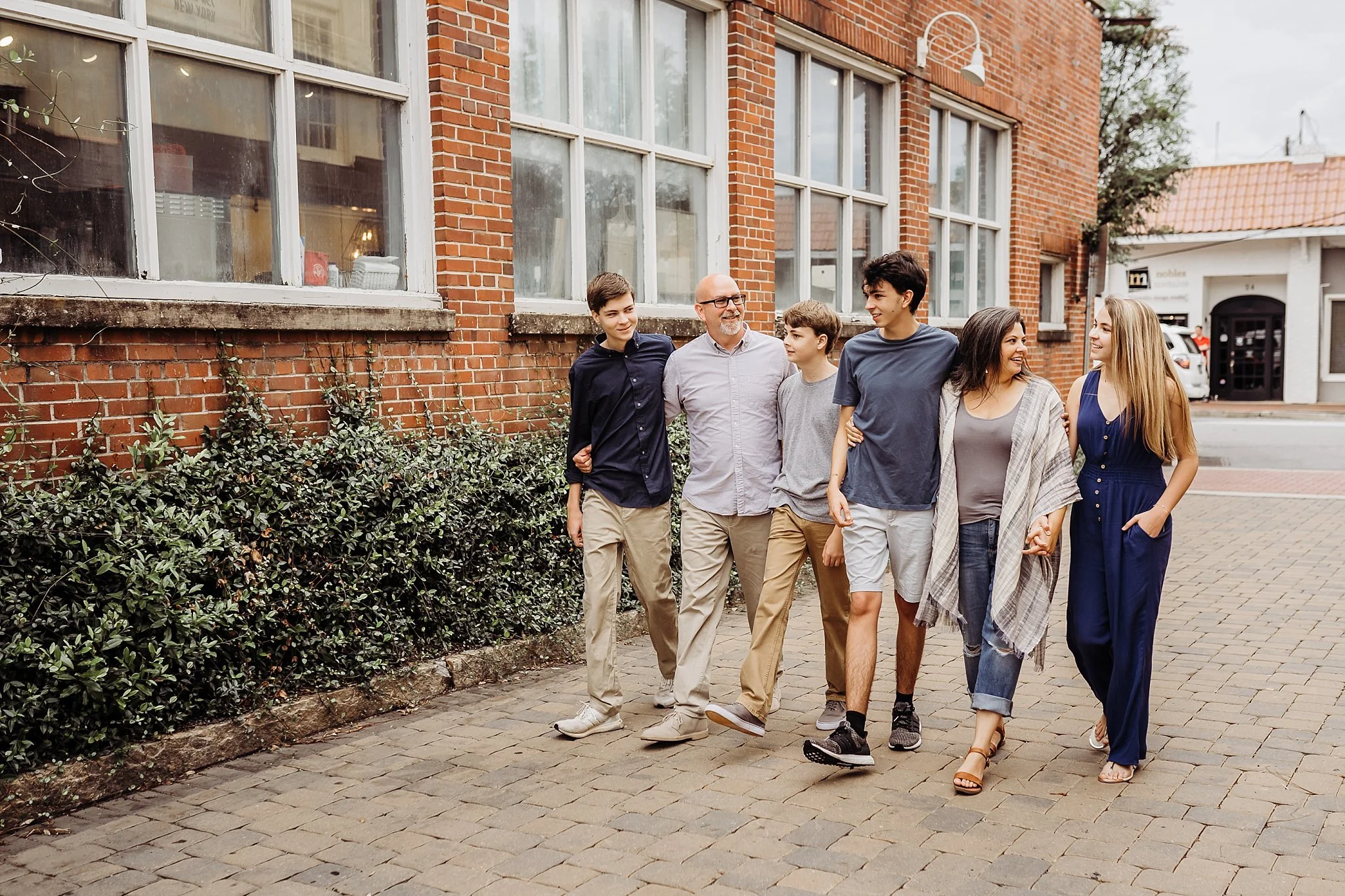 family of 6 walking through alley at Marrietta Square