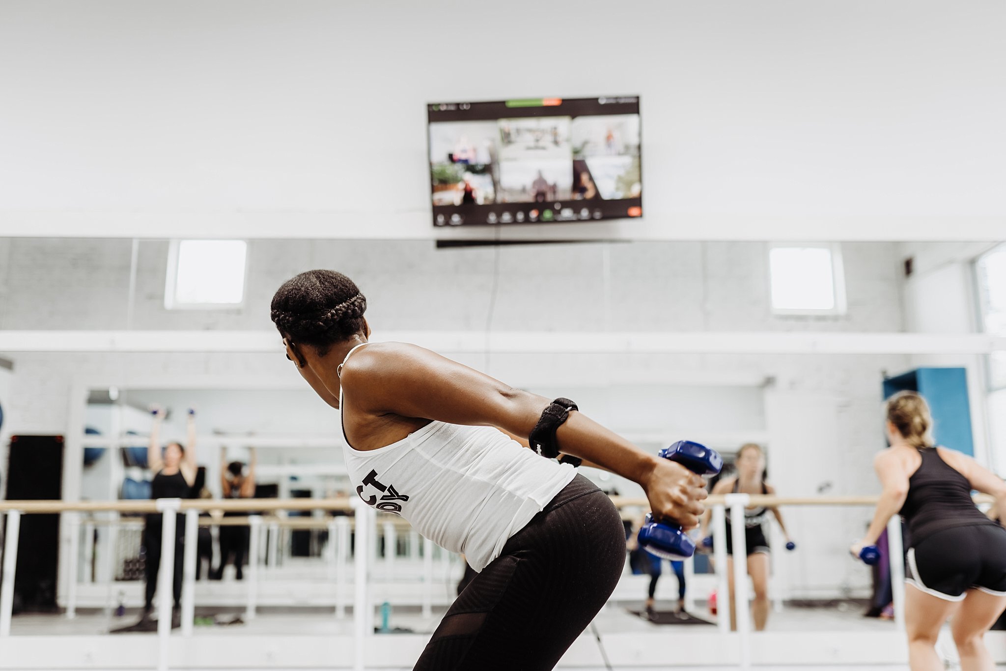 Trainer in gym teaching virtual live stream class