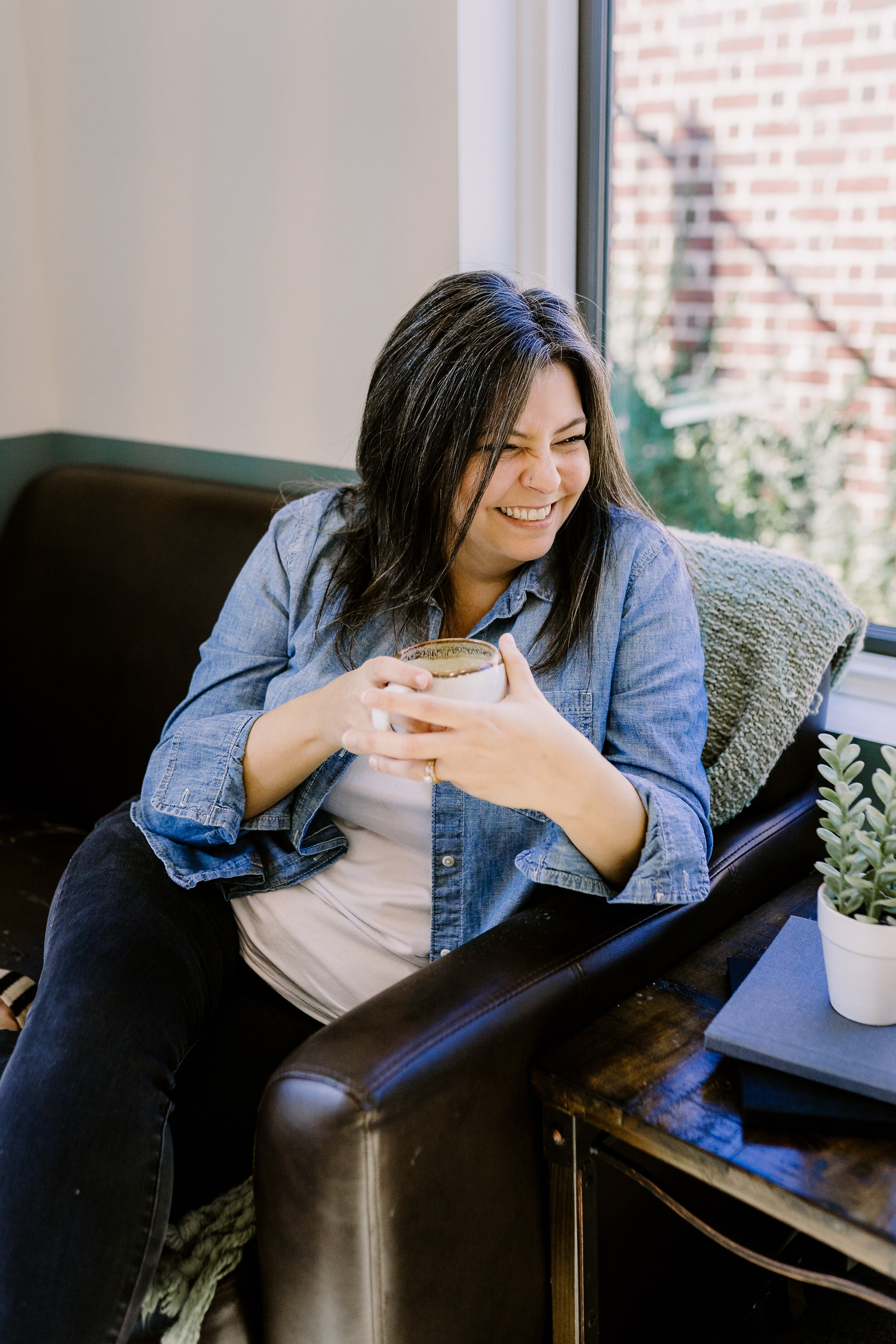 Lifestyle photo of photographer laughing and drinking coffee in Milton, GA