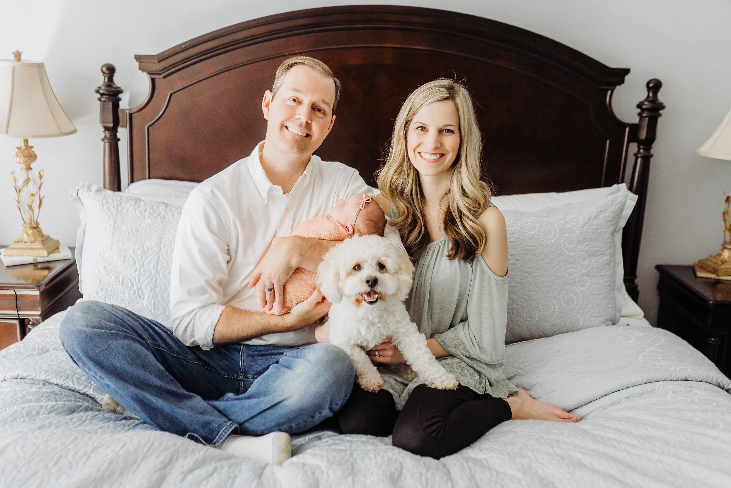 Family of 3 on master bed at in-home newborn session in Atlanta, GA