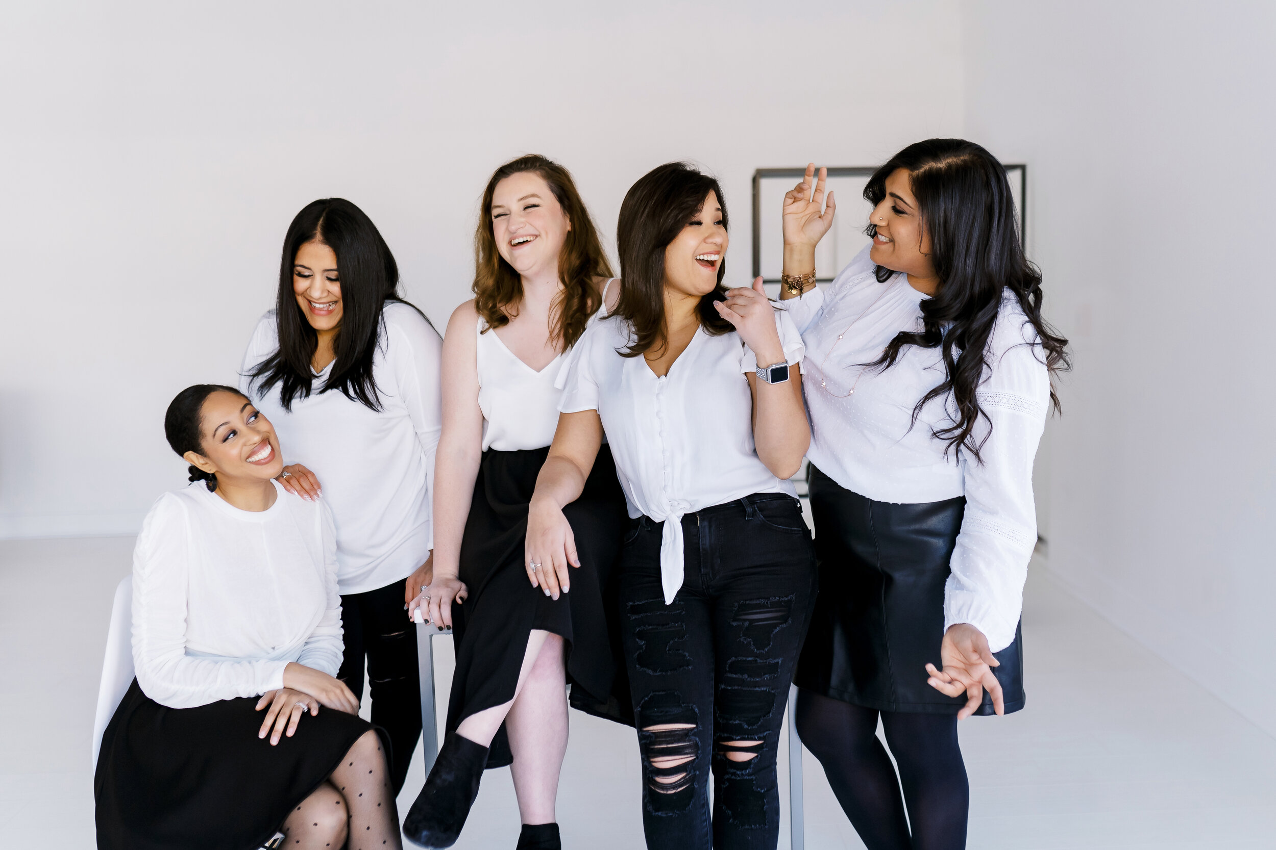 Open Door Talk Therapy team in black and white outfits laughing at personal brand photo session in Woodstock, GA