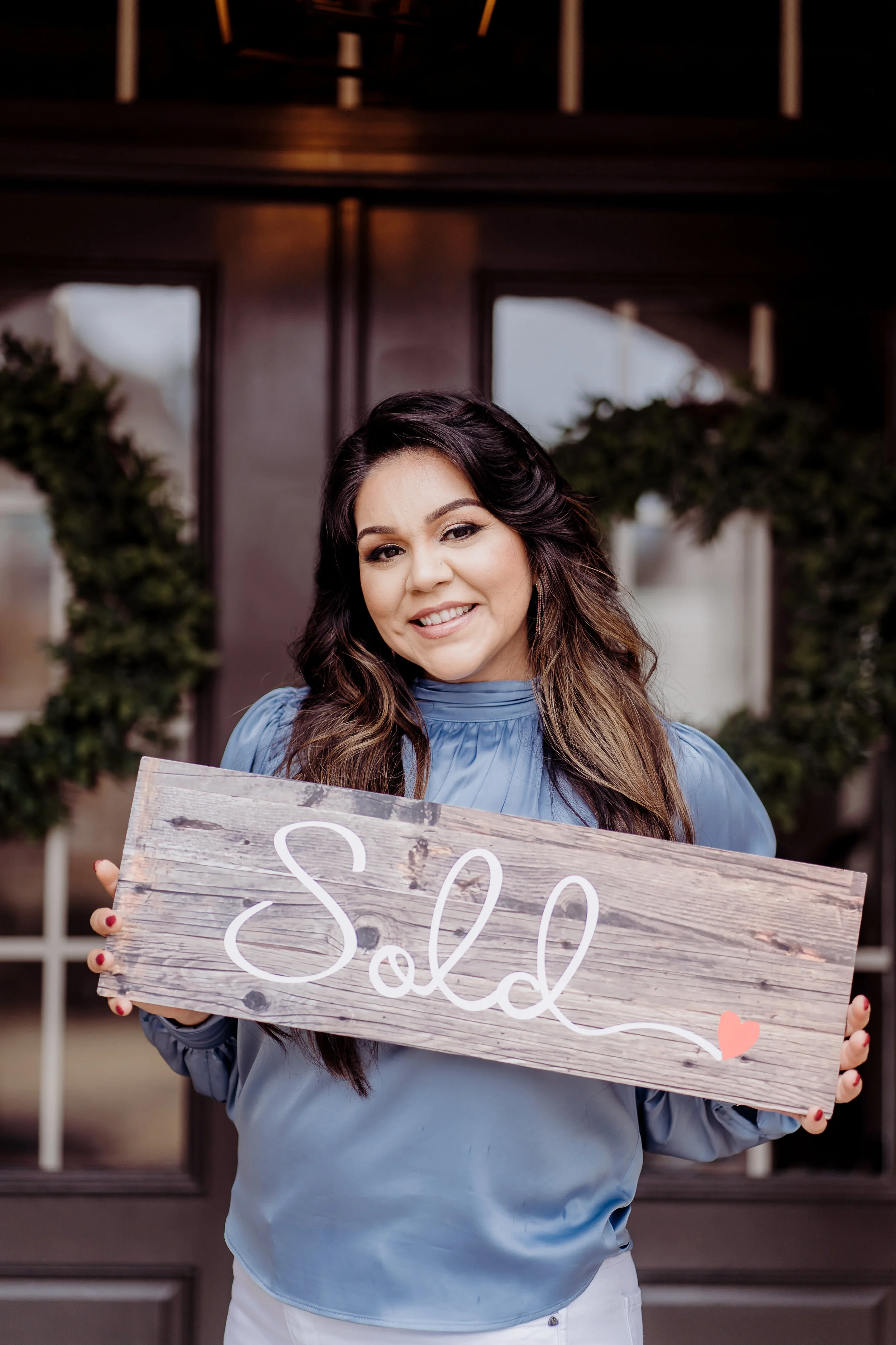 Realtor outside house holding sold sign Atlanta, GA Personal Brand Photo Session