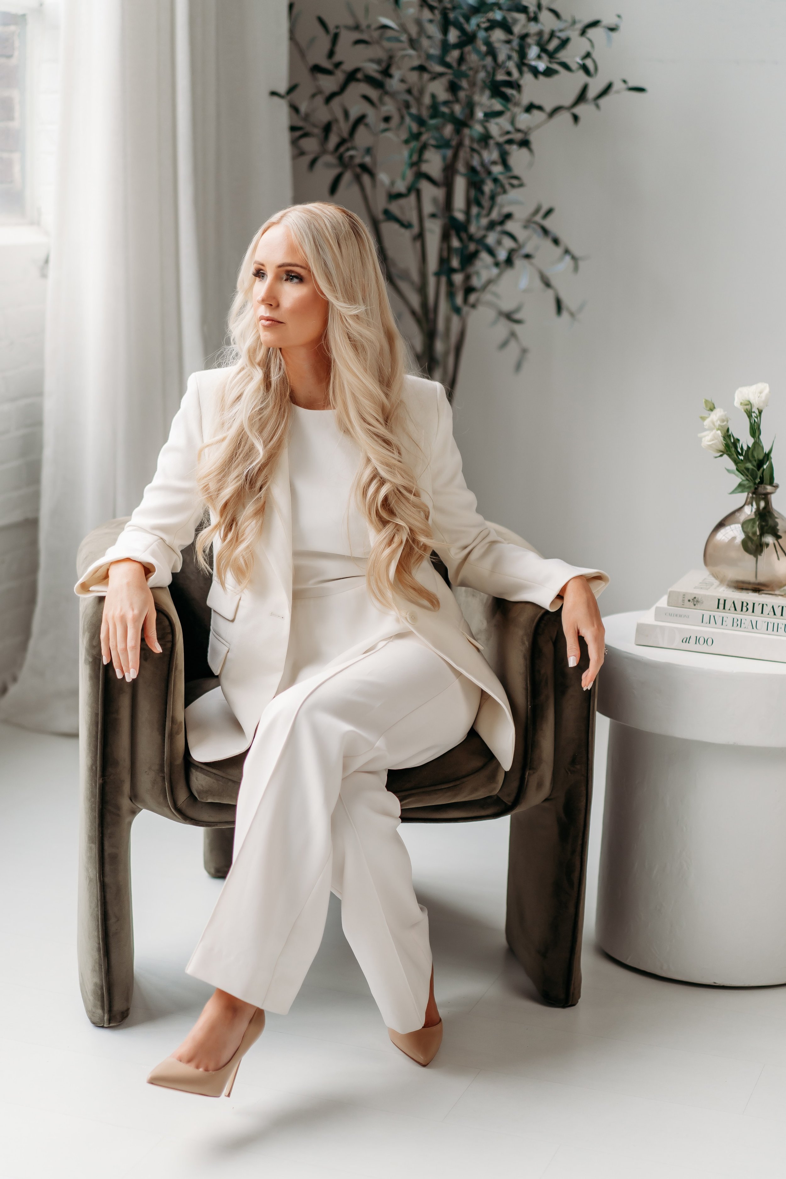 Interior designer sitting in green chair at Blanc Studio West in Atlanta for brand photos