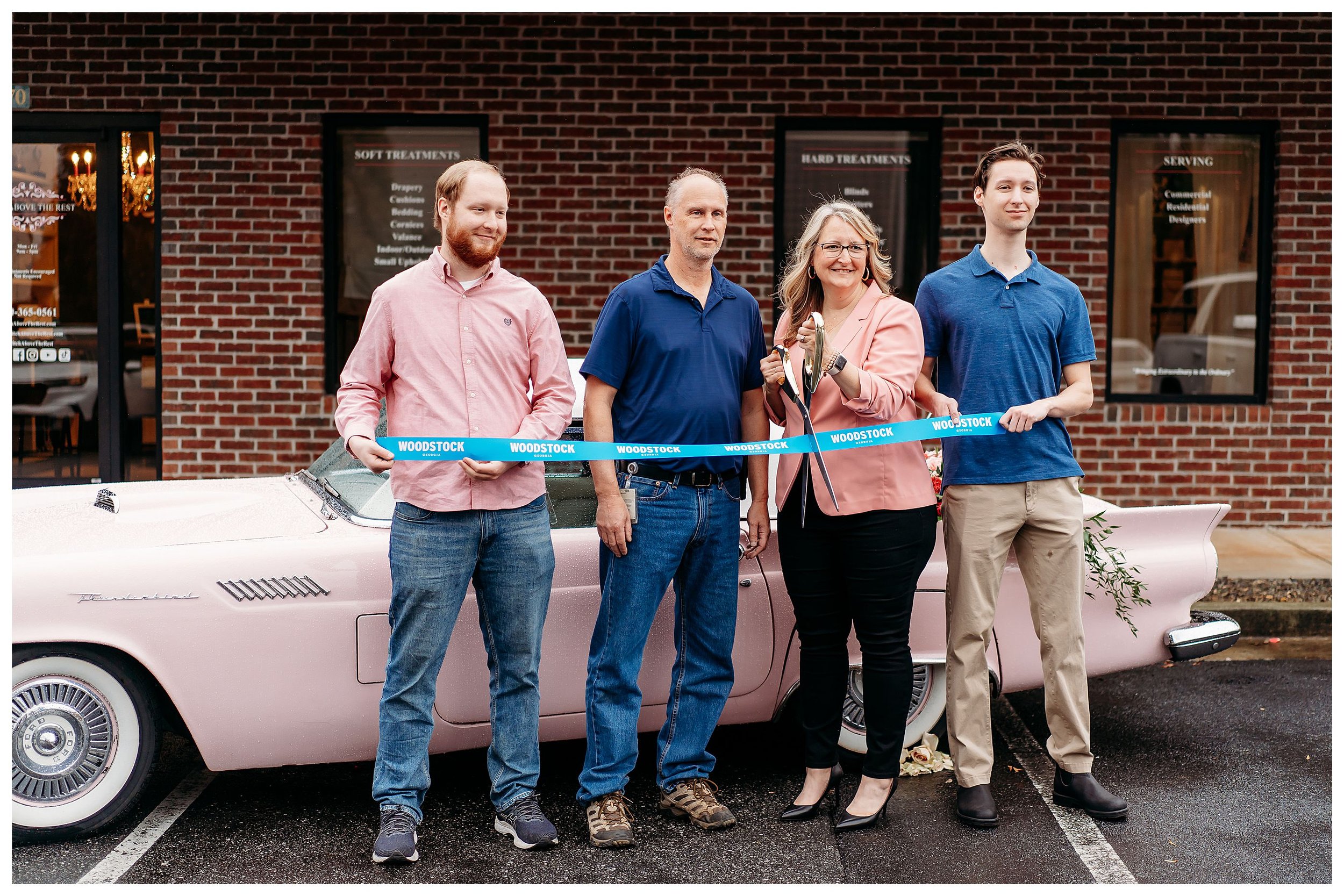 ribbon cutting family in front of pink car for Woodstock, GA business event