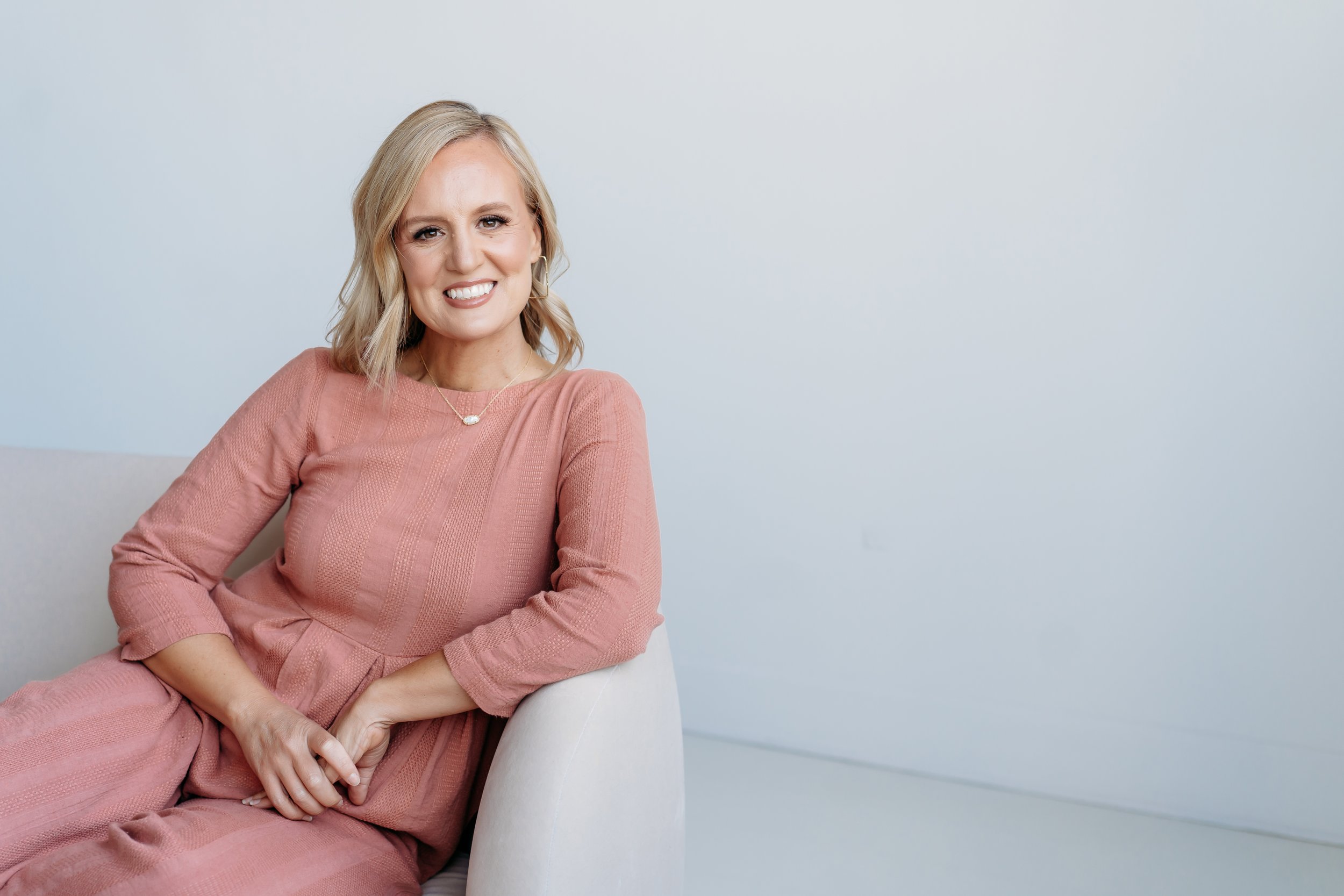 Atlanta Photographer sitting on couch for headshot