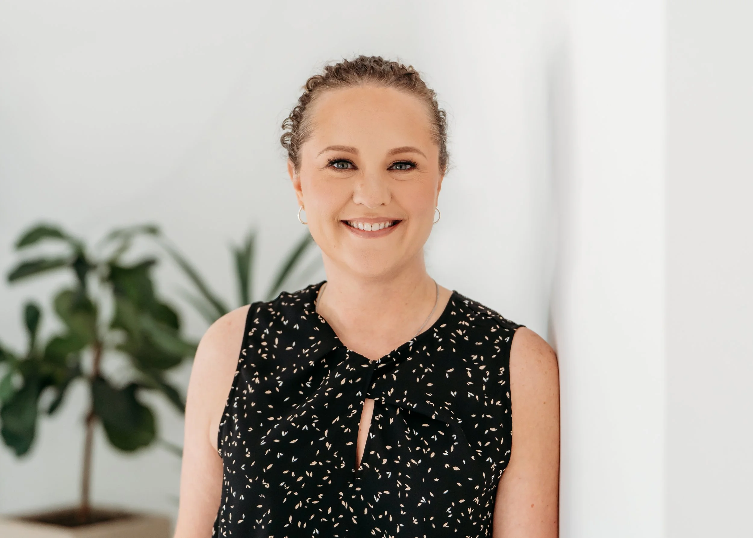 woman standing against white wall for Marietta Professional headshot session