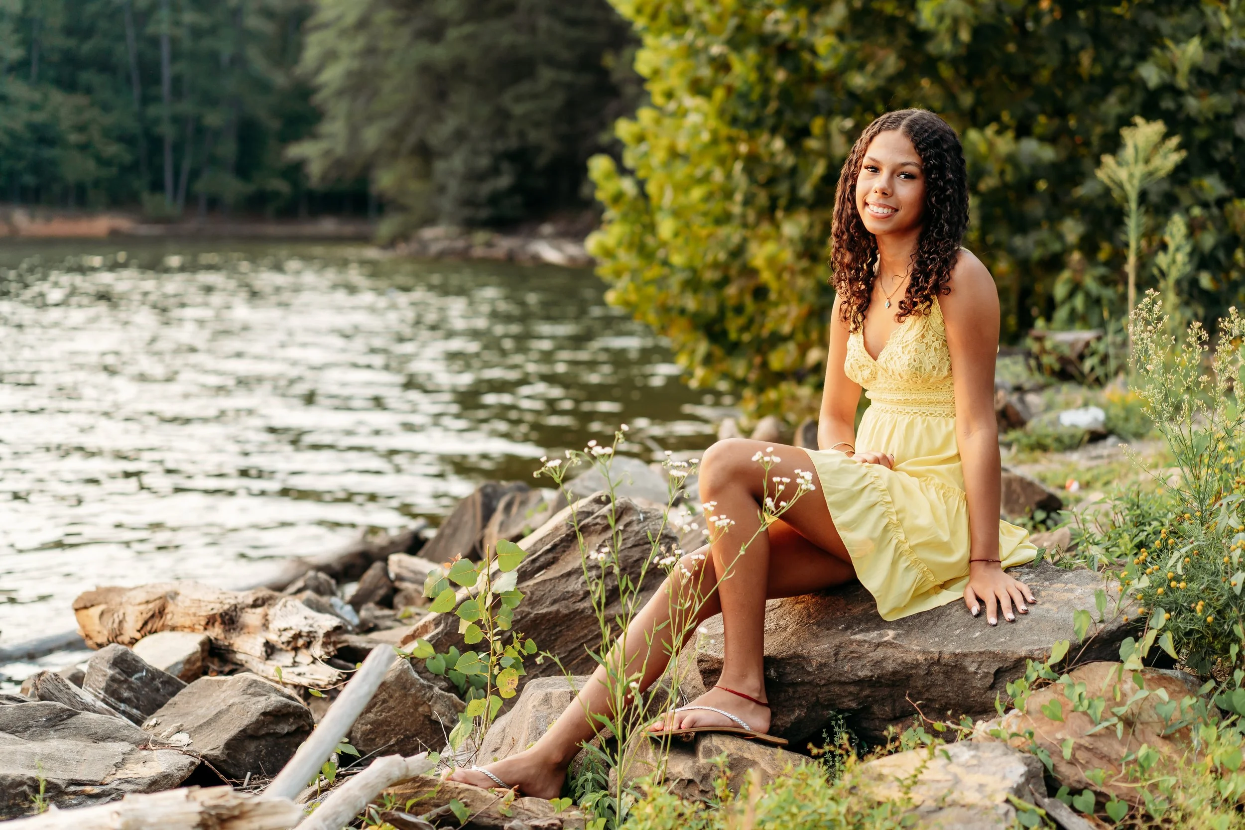 Girl sitting on rock for photos at Fields Landing Park in Canton, GA