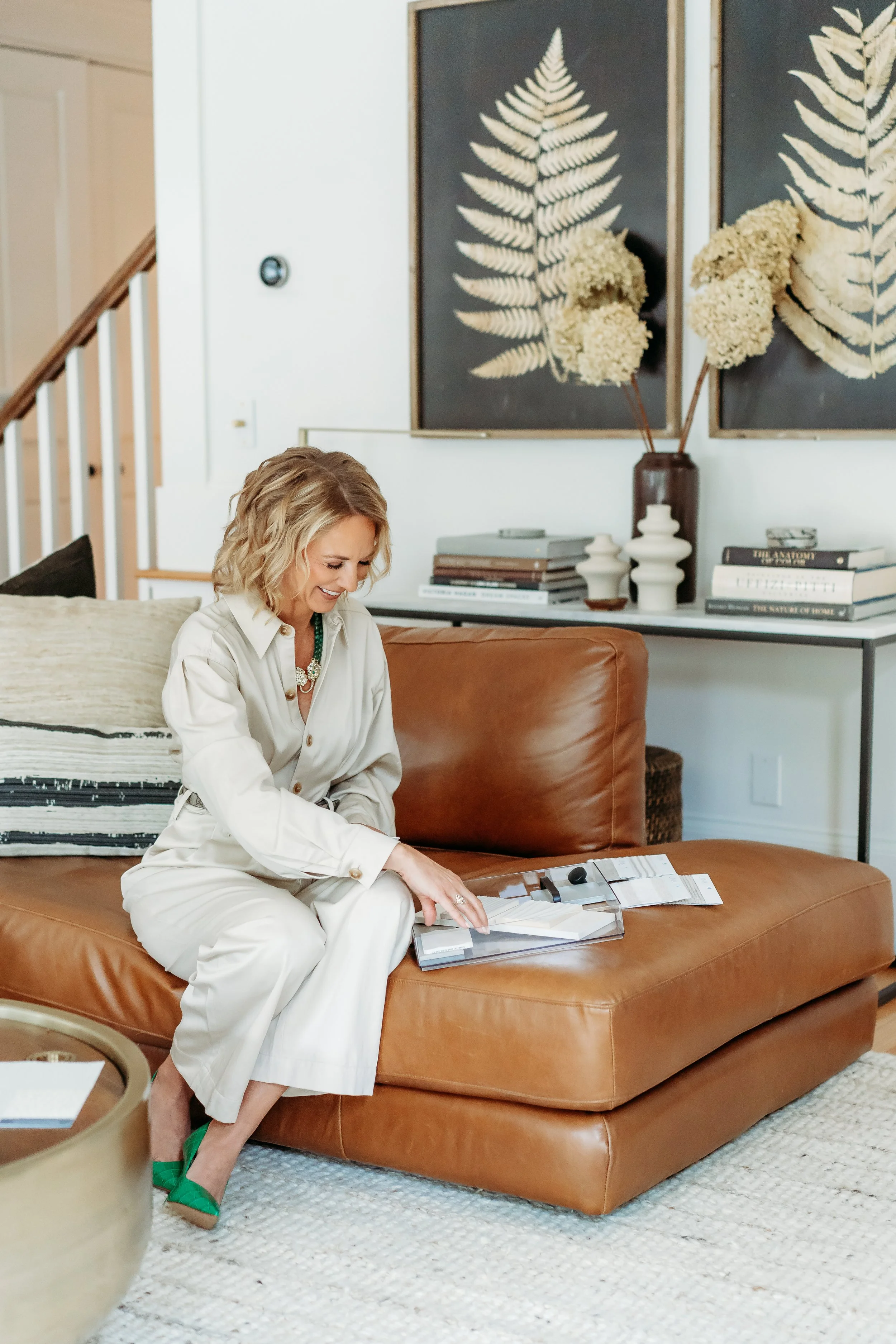 Lifestyle brand image interior designer in Cumming, GA home looking through samples