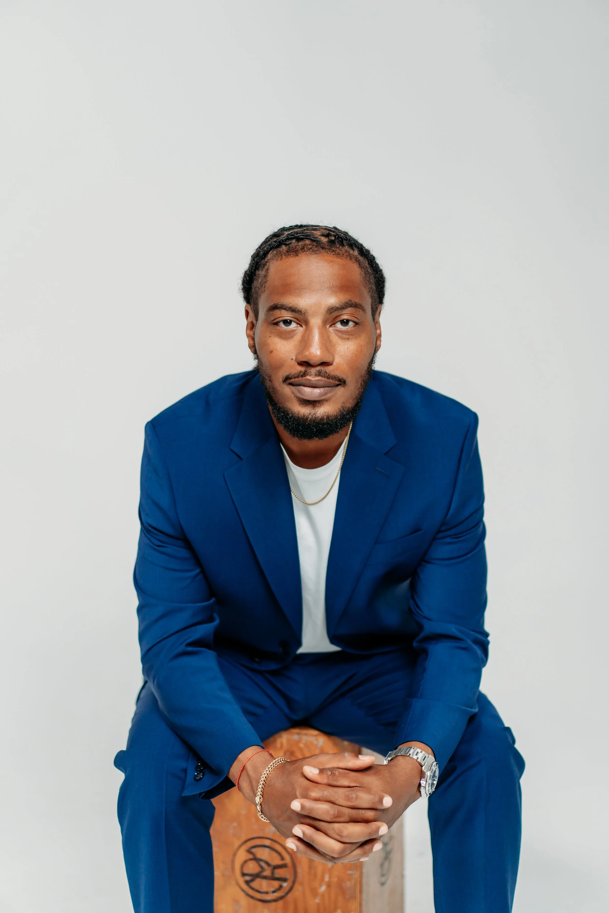 Man in blue suit leaning towards camera