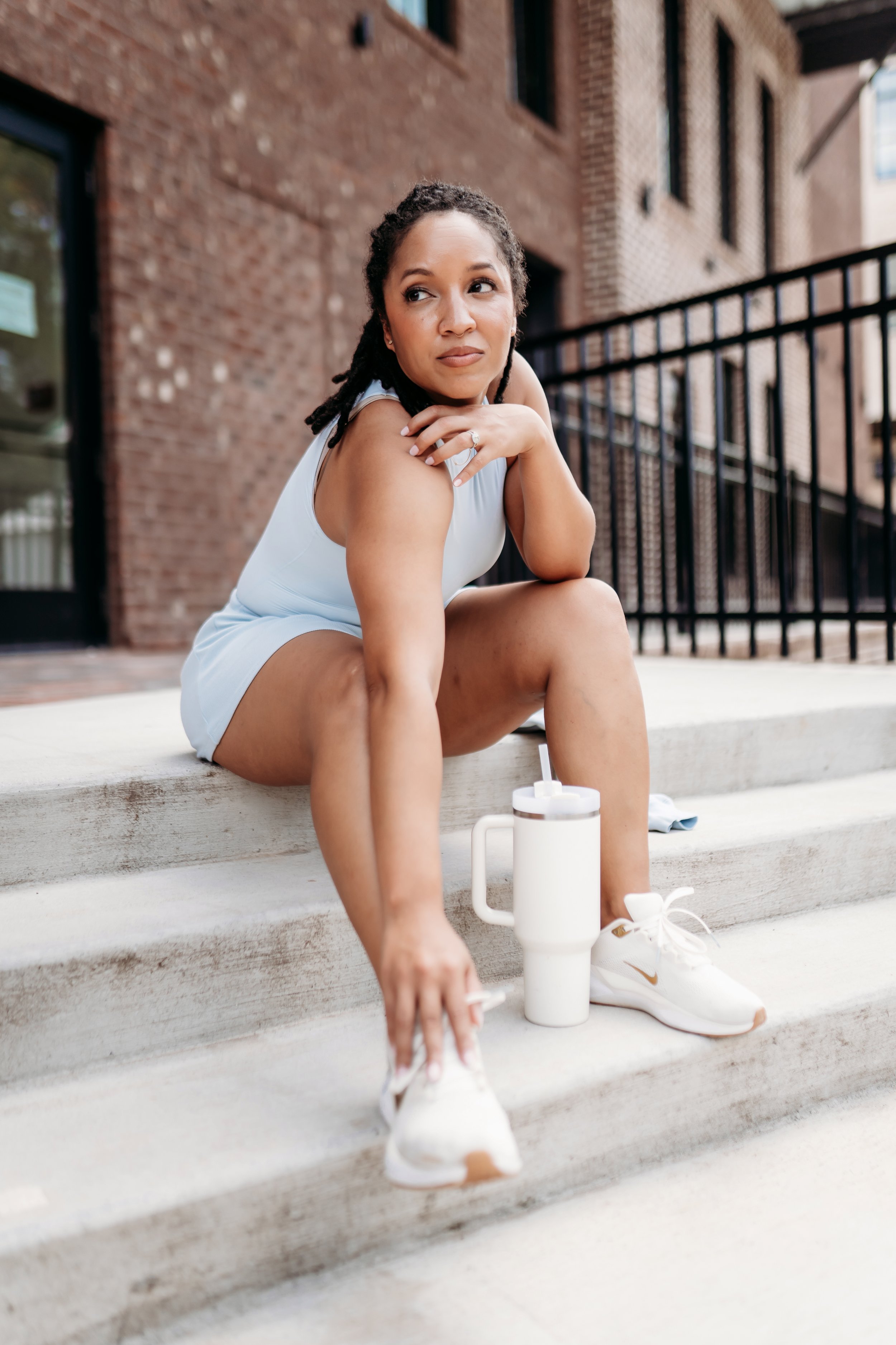 female athlete sitting on stairs as part of brand photoshoot in Milton, Ga