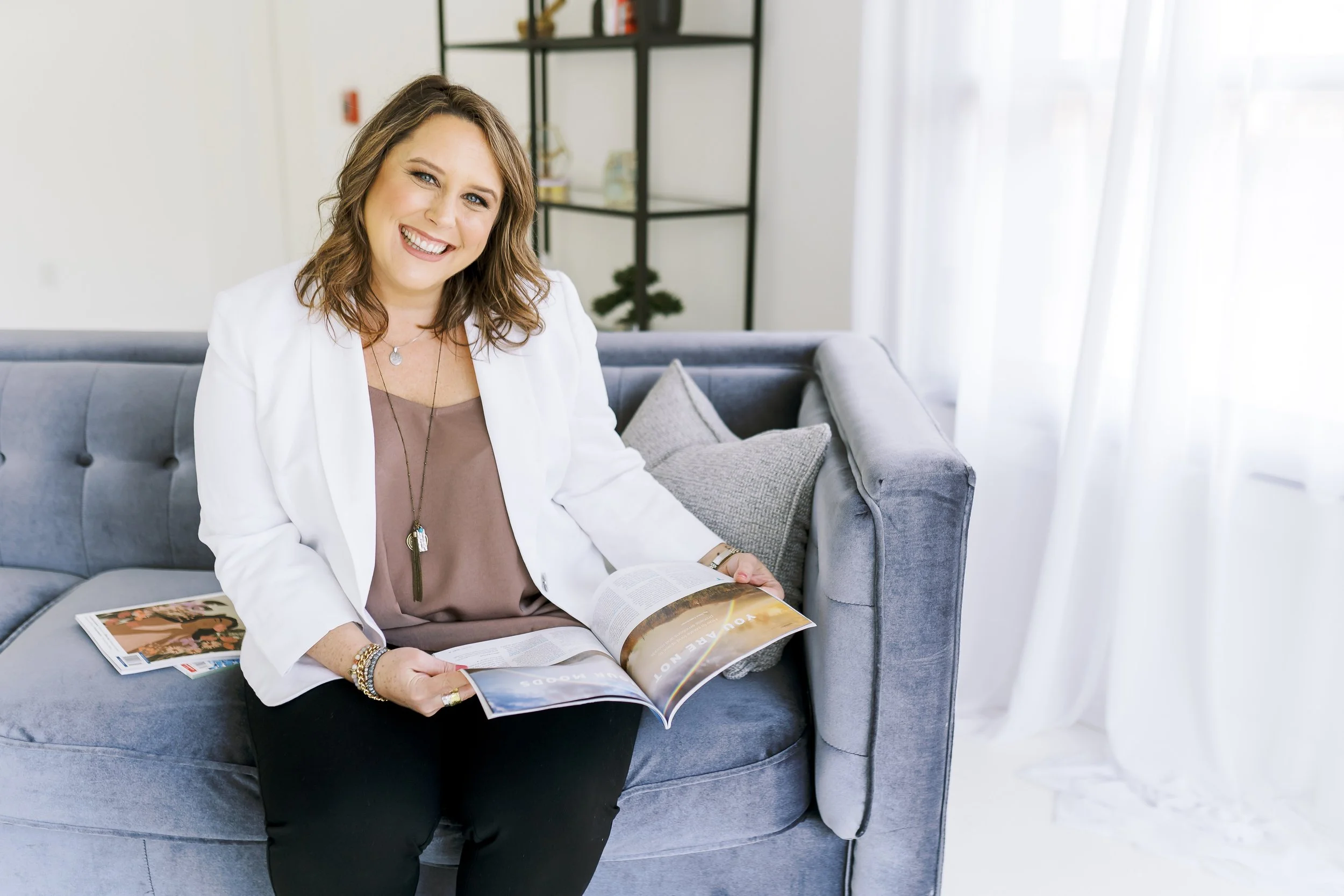 Coach sitting on couch looking at magazines for Atlanta Brand Photo Session