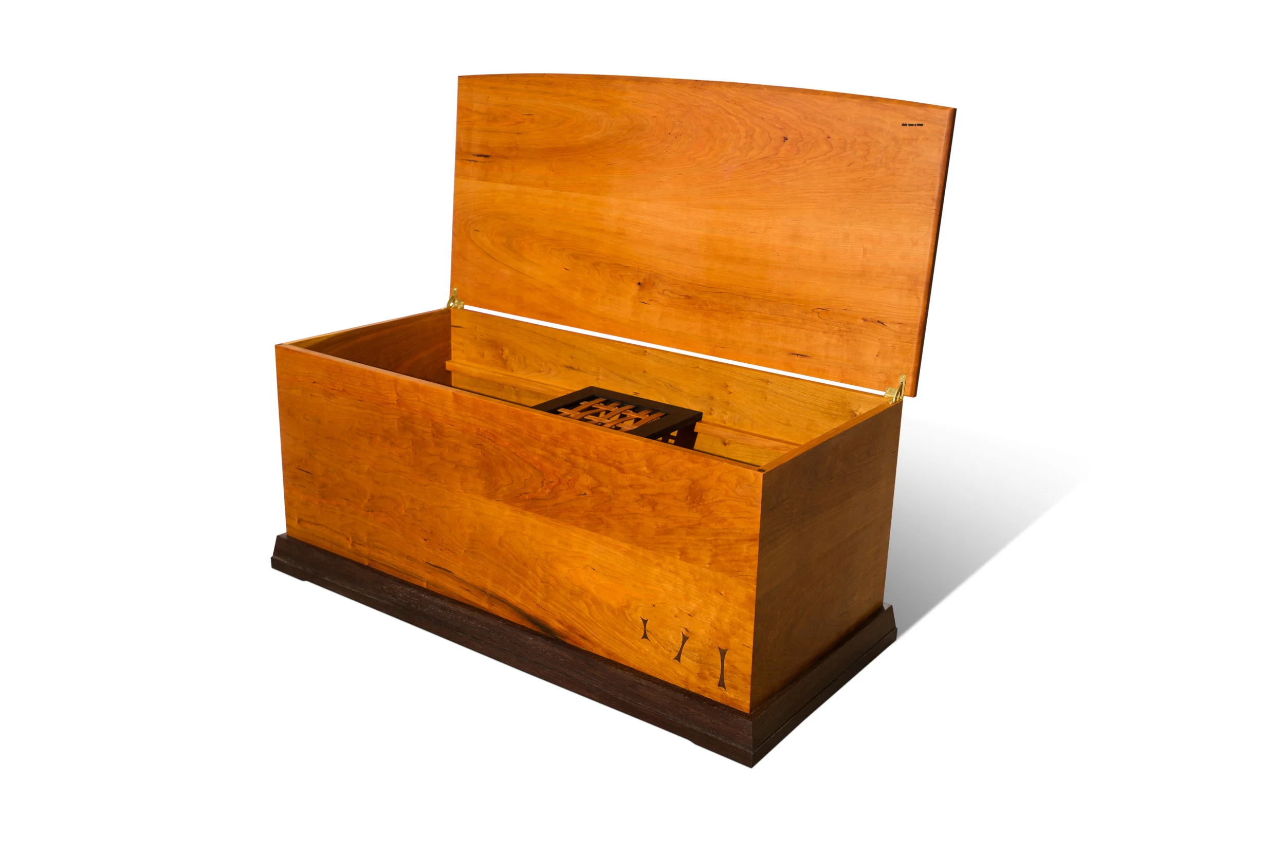 Benjie appreciates joinery, color and detail in his furniture. Dovetails, mortise and tenons and lock miters act both as strong joints and carefully considered features. Benjie seeks out those unique pieces of wood that nature has dyed in unexpected ways. He carefully selects bright red Paduk, high contrast light yellow and rich black and purple poplar, red orange cherry and deep purple walnut. Rest assured that each bevel, each proportion, each angle, and each material has been overthought and he has enjoyed every step of the process, except the pricing.