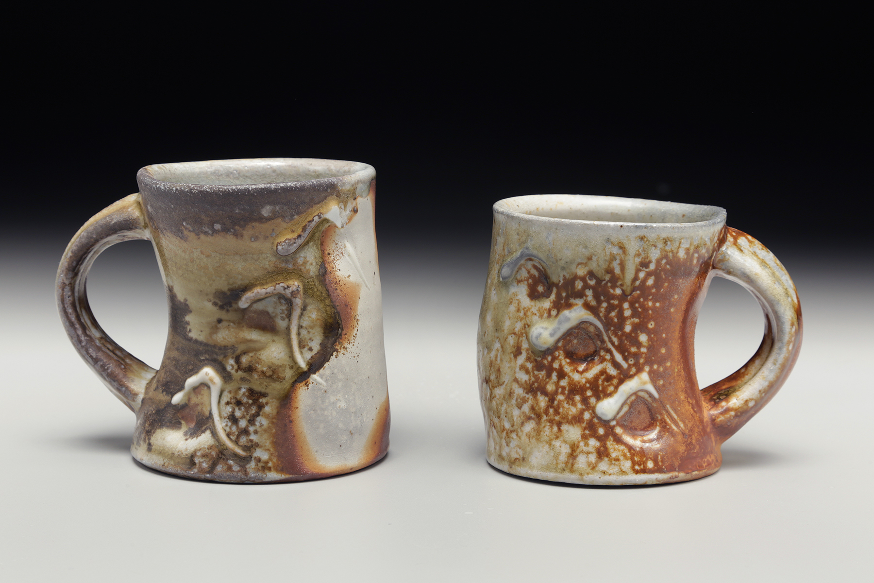 I began my explorations in clay almost 14 years ago. I was seduced by the material and the wheel, and the idea that I could create something beautiful and useful at the same time. My interest then fell into surface and color, using textural porcelain slips and layered glazes to create bright, flowing, and volatile surfaces. As I have grown and matured in life, my work has followed. I am still fascinated by glaze and surface, but with a higher understanding of form and flow. I am deeply influenced by classical shapes and why and how they were made. I attempt to embrace these studied forms but with a contemporary twist. In my current method of firing in a large two chamber wood kiln I am exploring the interaction between form and fire; building a relationship in the piece between the function, surface, and the story of the firing process. Each pot is made and placed in the kiln conscientiously with an expectation and openness. A desire for success, and a pupil’s acceptance of result.