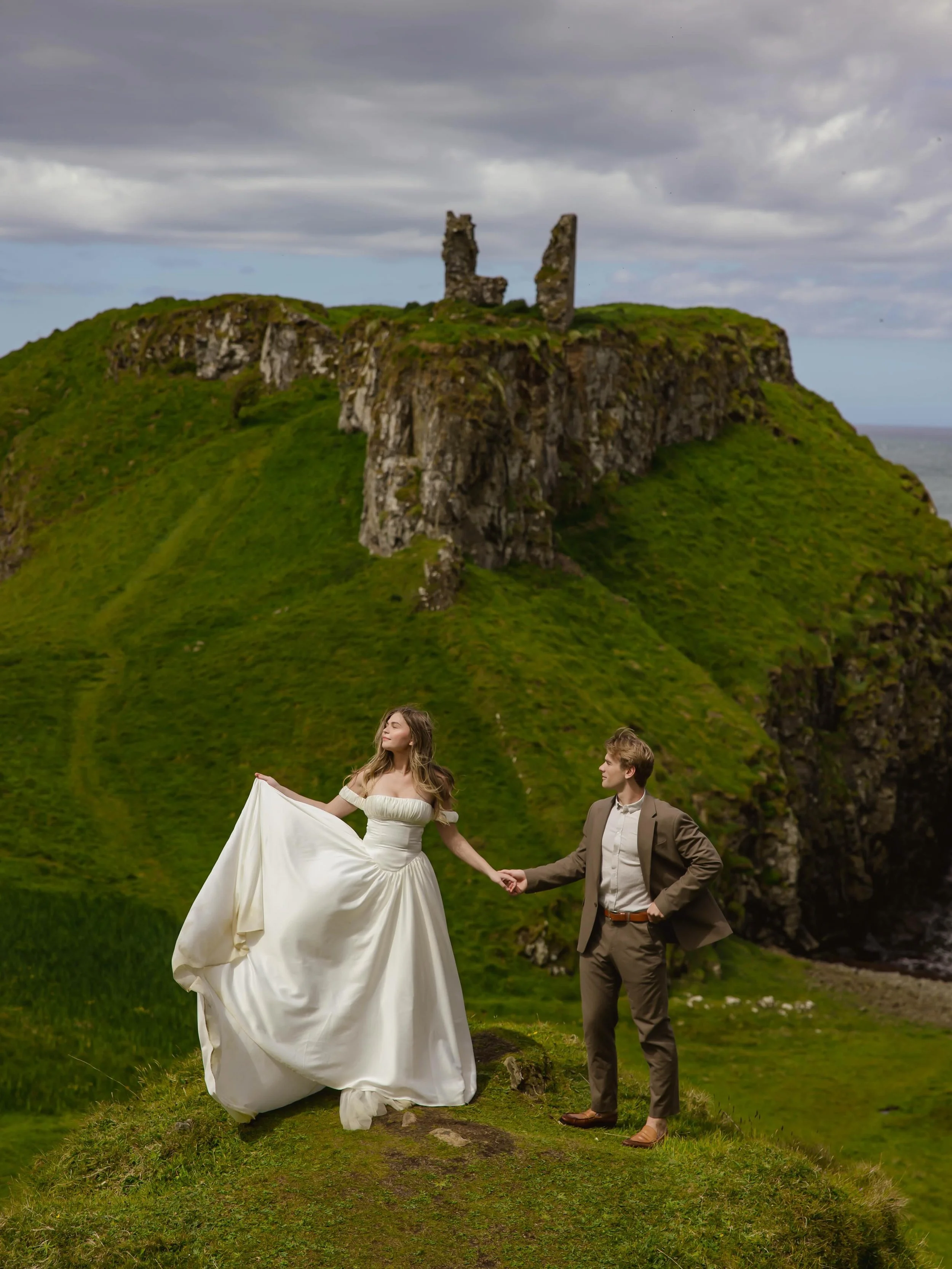 Some places don&rsquo;t feel real until you stand in them.
&bull;
&bull;
Host: @vowandventure.co
Elopement: @itschloethiessen 
Dress: @rawgoldenrentals 
#DunseverickCastle #IrelandWeddingPhotographer #IrelandElopement #DestinationWeddingPhotographer 