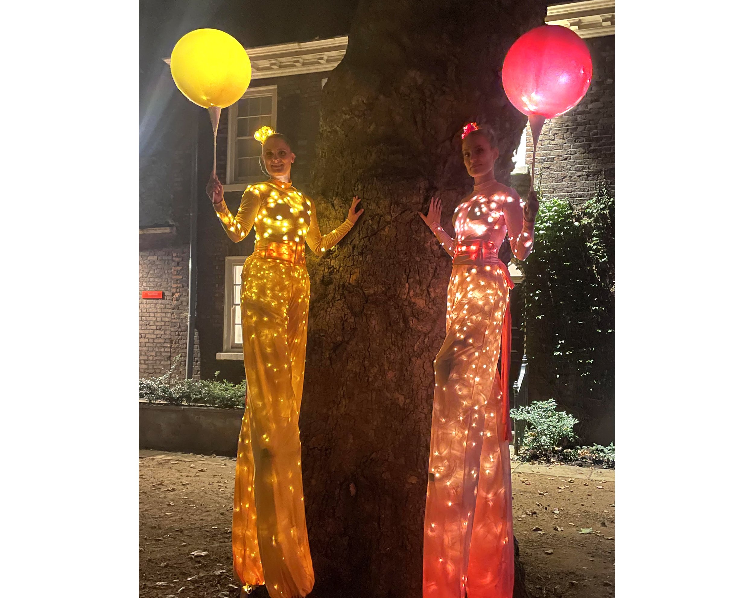 Colour Collection, illuminated stilt performance in pink and yellow with LED balloons, Divine Company.jpg