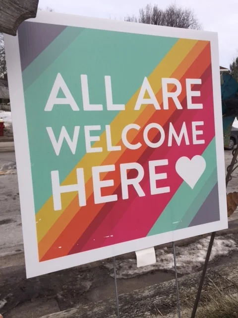 A sign. Two crumpled cars. And a promise.