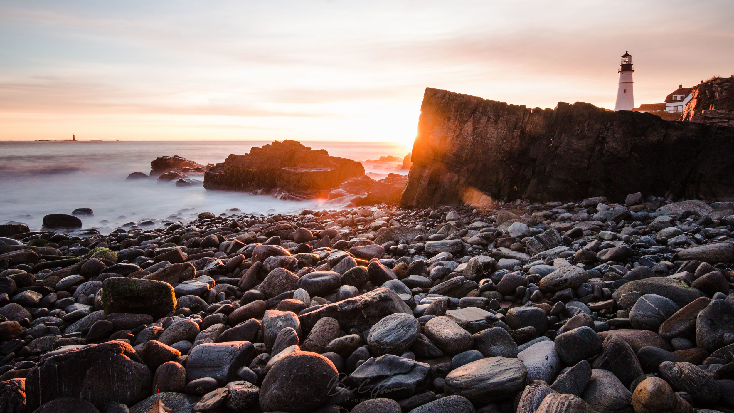 Lighthouse Rocks Sunrise Long Exposure at Portland Head Light in Cape Elizabeth, Portland, Maine.