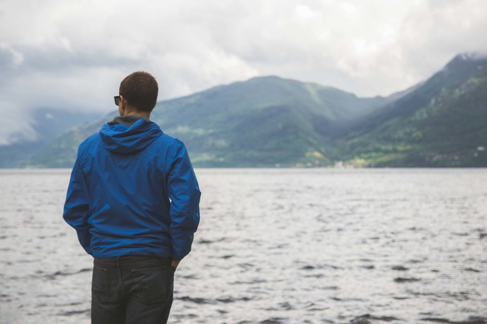 Hiking Man Looking at Norwegian Fjord