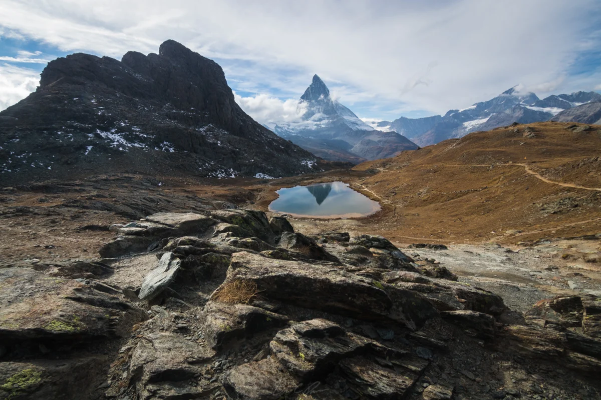 Riffelsee an alpine lake reflecting the prominent Matterhorn.
