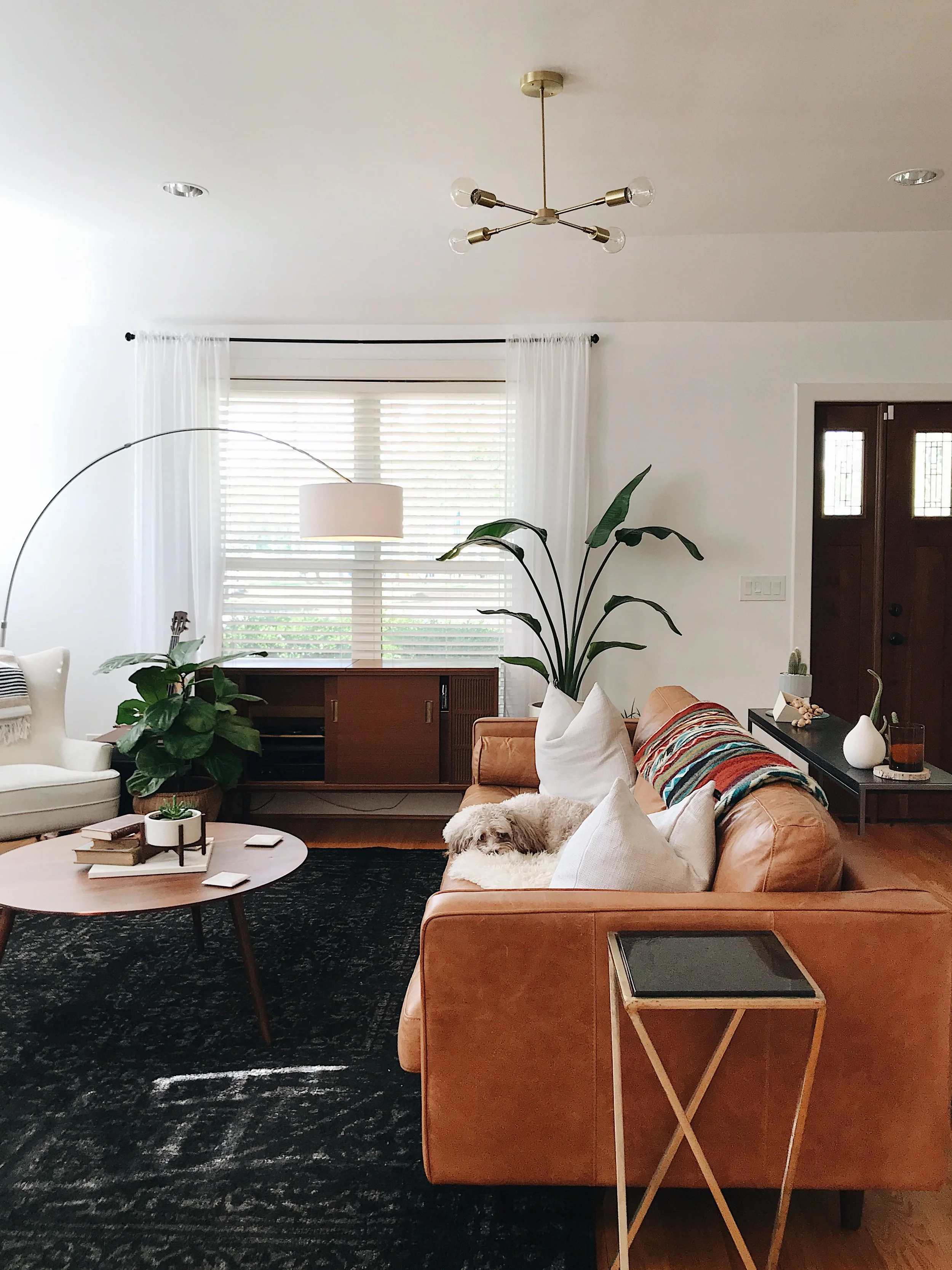 Odyssey Chandelier from Schoolhouse, Sven Sofa and coffee table by Article, Rug from RugsUSA, blanket by Ecuadane, and planters by Modernica.