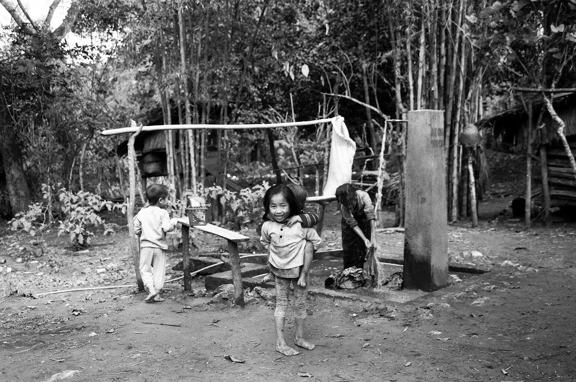 These photographs were taken in Northern Laos about an hours car ride from Luang Prabang. The two photographed villages are home to the Hmong and Khmu people of Laos. Historically, these ethnic minorities have been oppressed and escaped persecution by fleeing to higher altitudes. Luang Prabang and the surrounding area is a hyper center for 'ethical tourism'. Today many Hmong and Khmu people living in rural villages continue to experience high rates of poverty. Despite many of its negative repercussions, tourism offers a viable means for economic mobility for many living within these communities. That being said tourism is not a sustainable solution and economic growth needs to circulate locally for the community to succeed independently. Clear consent was given by all photographed individuals. 