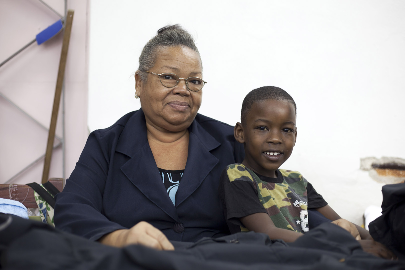 Co-founder Miguelina, 58, and her grandson Dalien, 5, Cooperativa no agropecuaria Confecciones Model