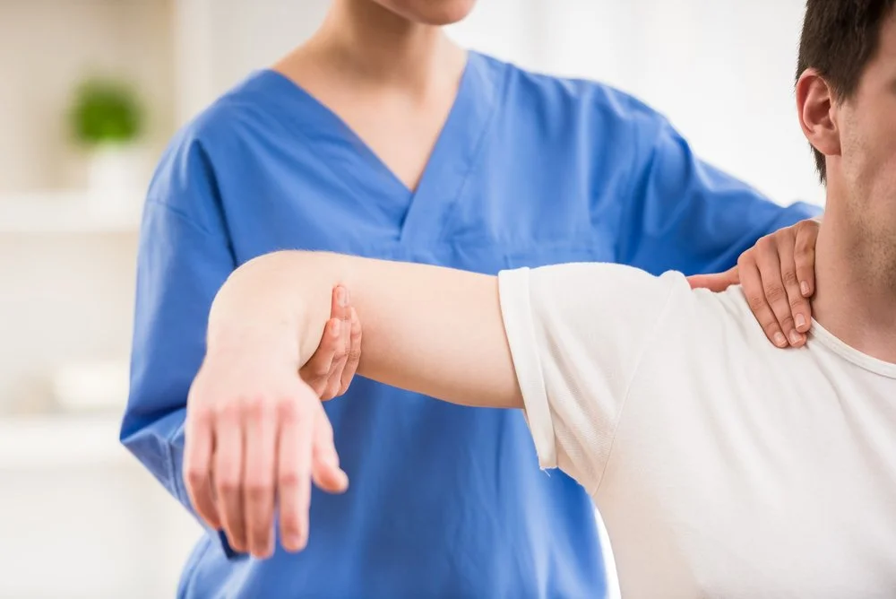 professional giving physical therapy to man