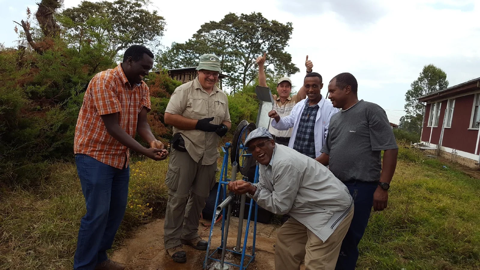 Fixing a broken water pump outside a rural healthcare center in southwest Ethiopia that had no water for months.