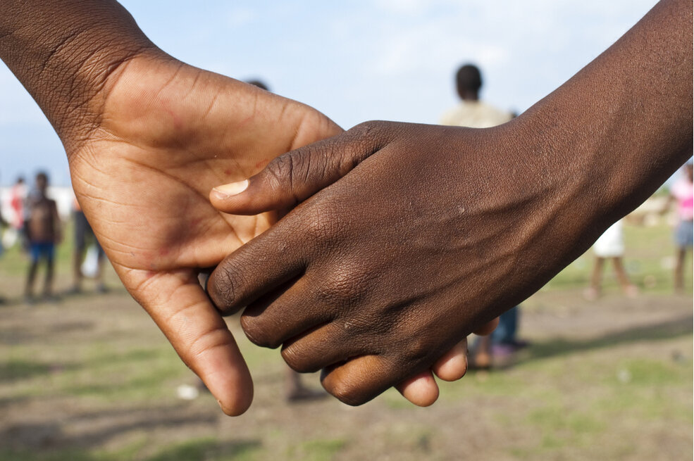 Children holding hands in Léogâne, Haiti. KSK Imaging/shutterstock