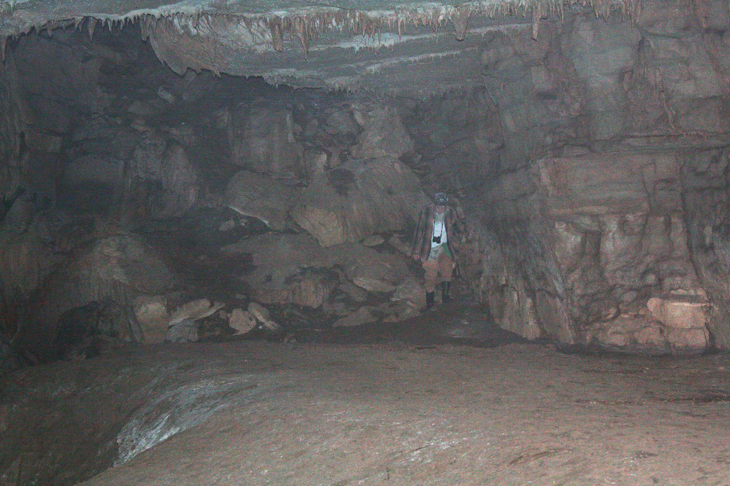 Out of the darkness appears Dick Bartlett.  To the bottom left of the photo you can make out a slope.  This slope is 50 slippery feet to the bottom. 