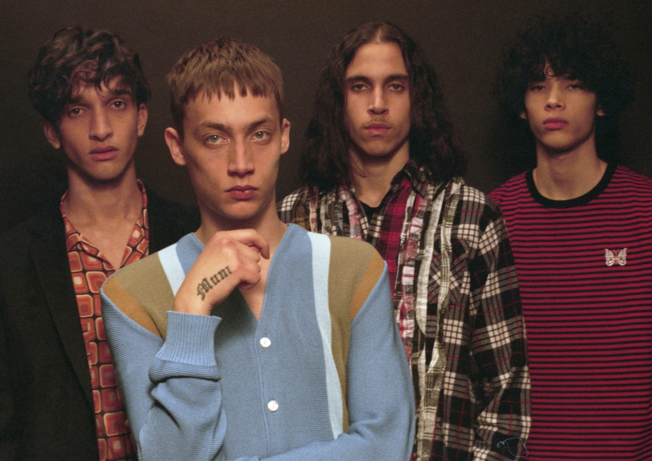 Jamie: Cardigan Needles Emmanuel: Flannel Shirt - Needles, Ribbon Noah: Sateen Shirt - Needles, Suit - Maison Kitsune Akeem: Red striped T-Shirt - Needles
