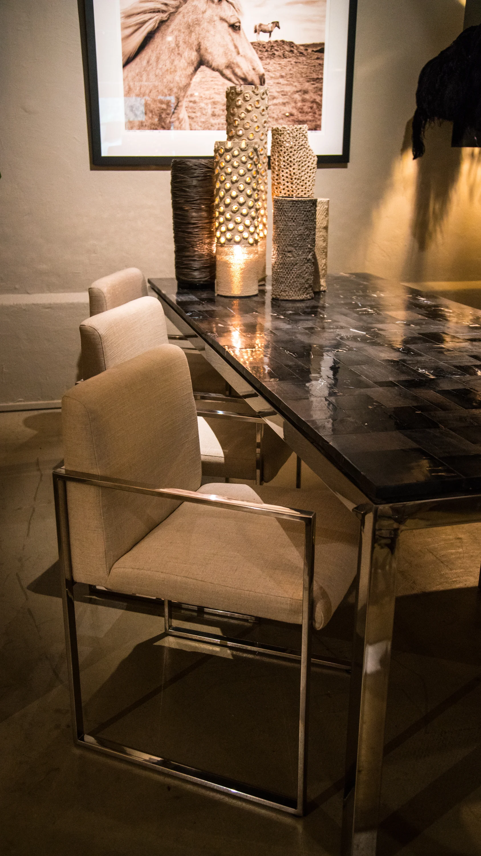 petrified wood dining table, pierced stone vases & table lamps, wall photo print, fabric & steel dining chairs