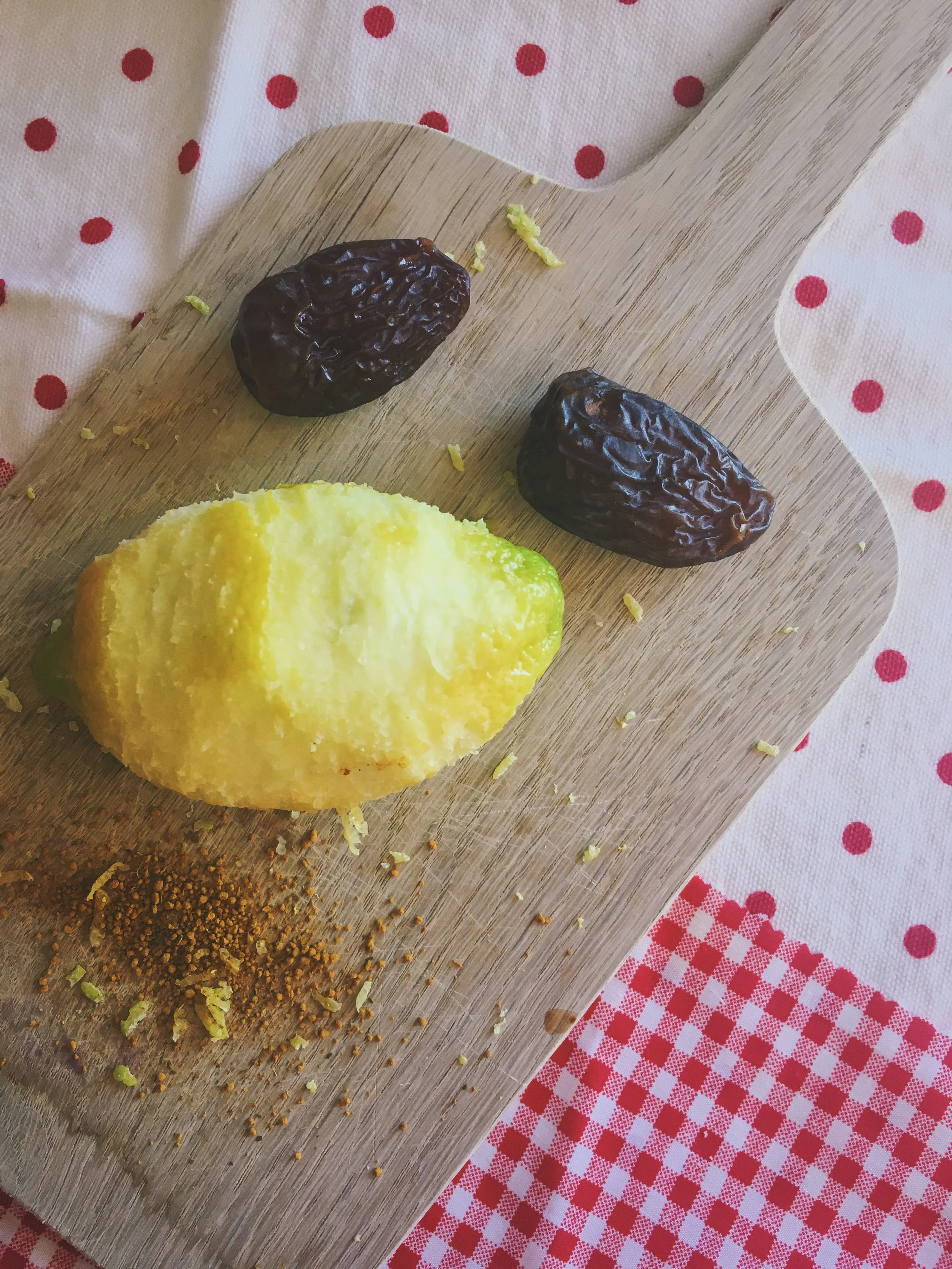 lemon zest, medjool dates and turmeric on a wooden board 