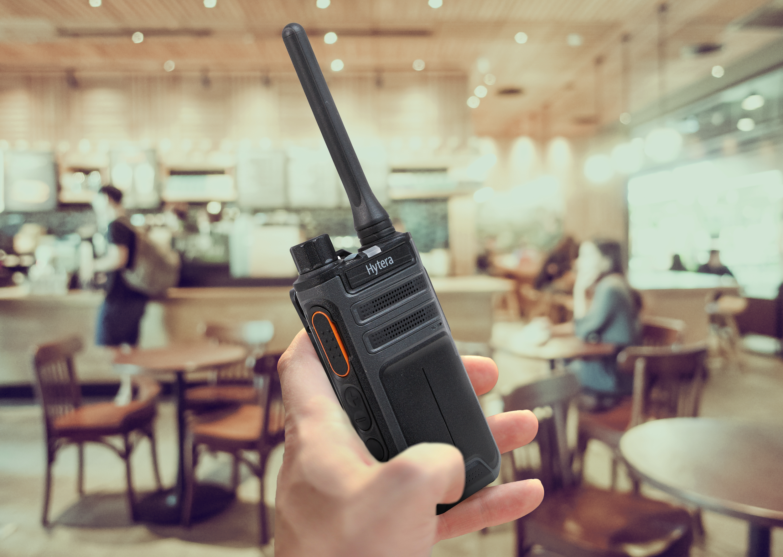 Radio in hand angled AP515 in Restaurant.png